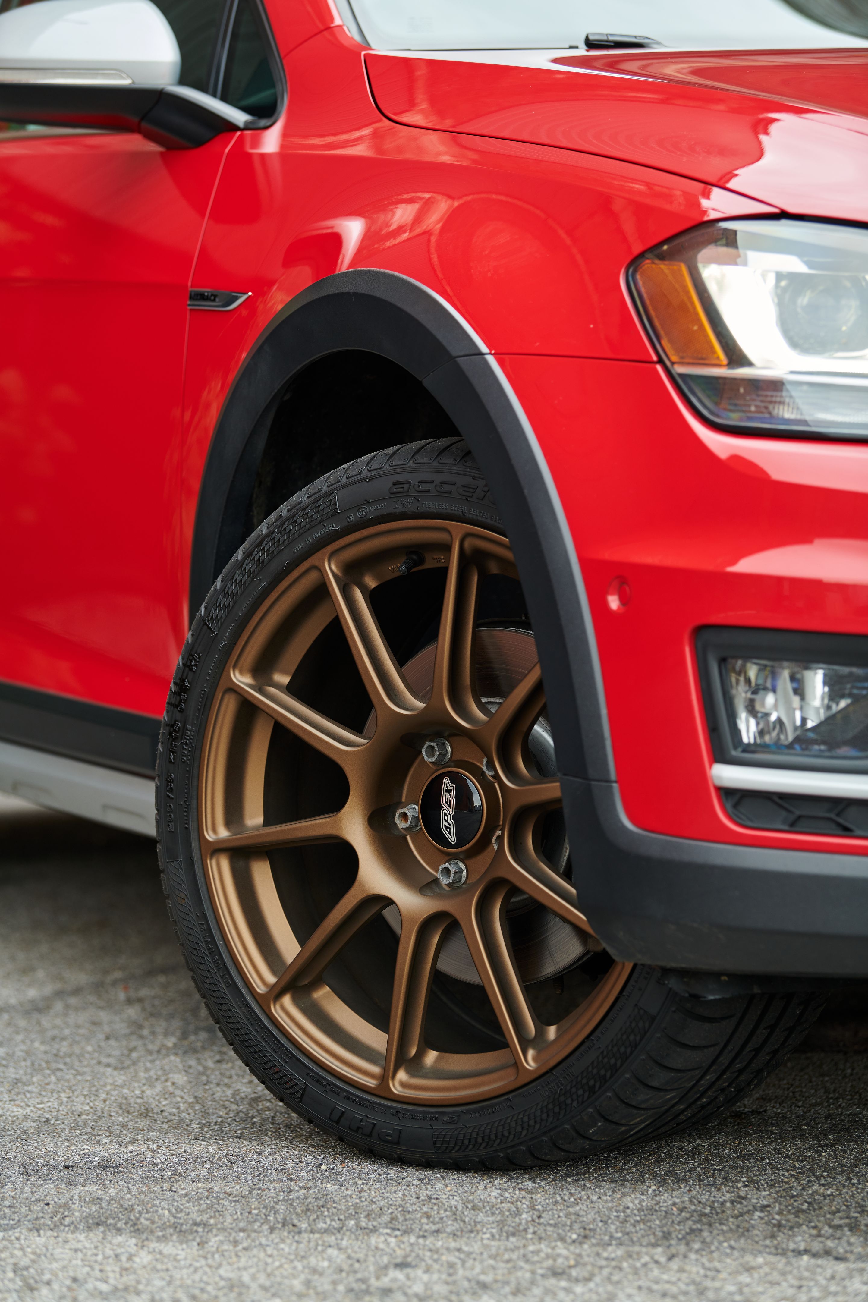 Red VW MK7 Alltrack/SportWagen Alltrack with 18" SM-10 Apex wheels in Satin Bronze