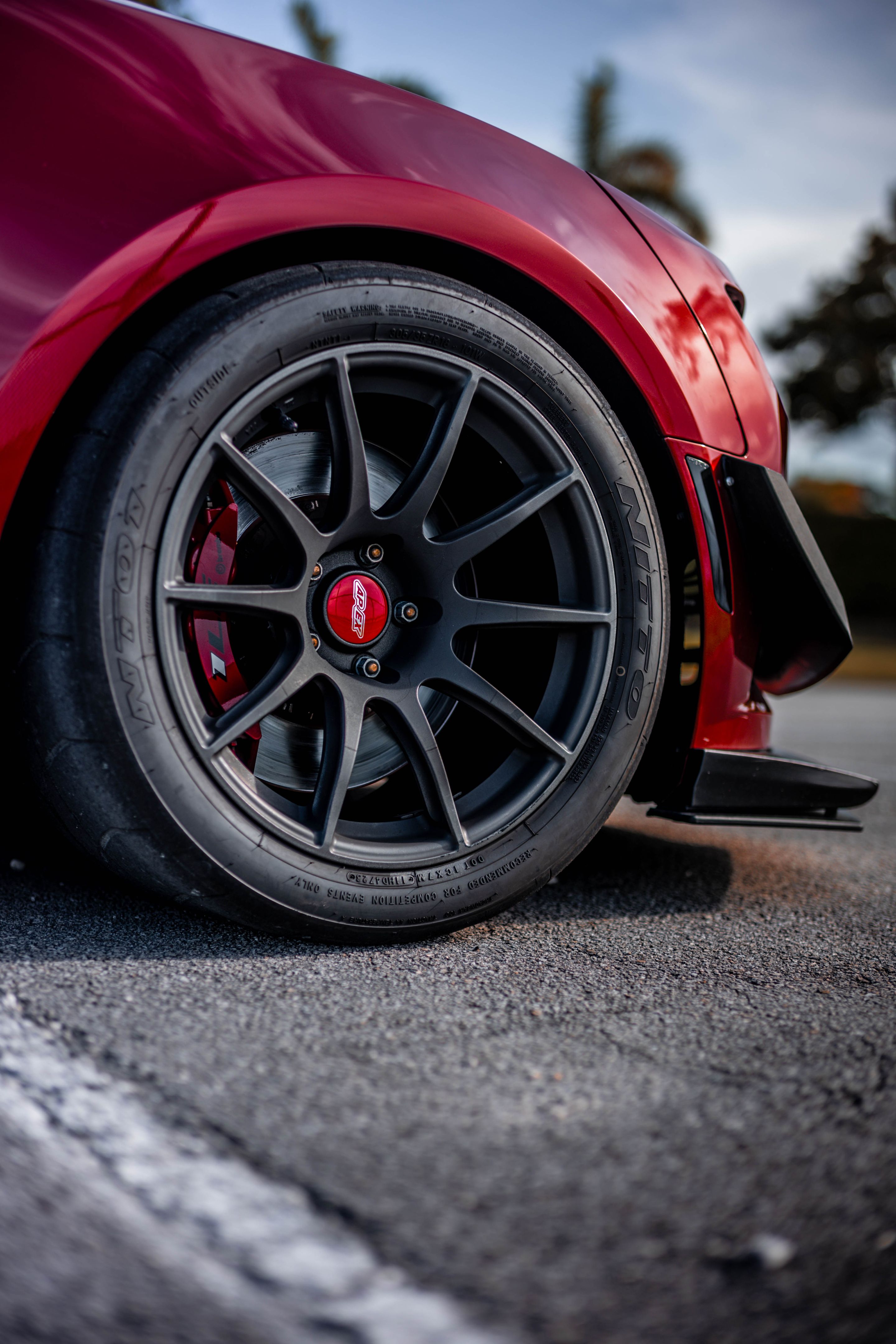 Red Chevrolet 6th Gen Camaro SS with 19" SM-10 Apex wheels in Satin Black