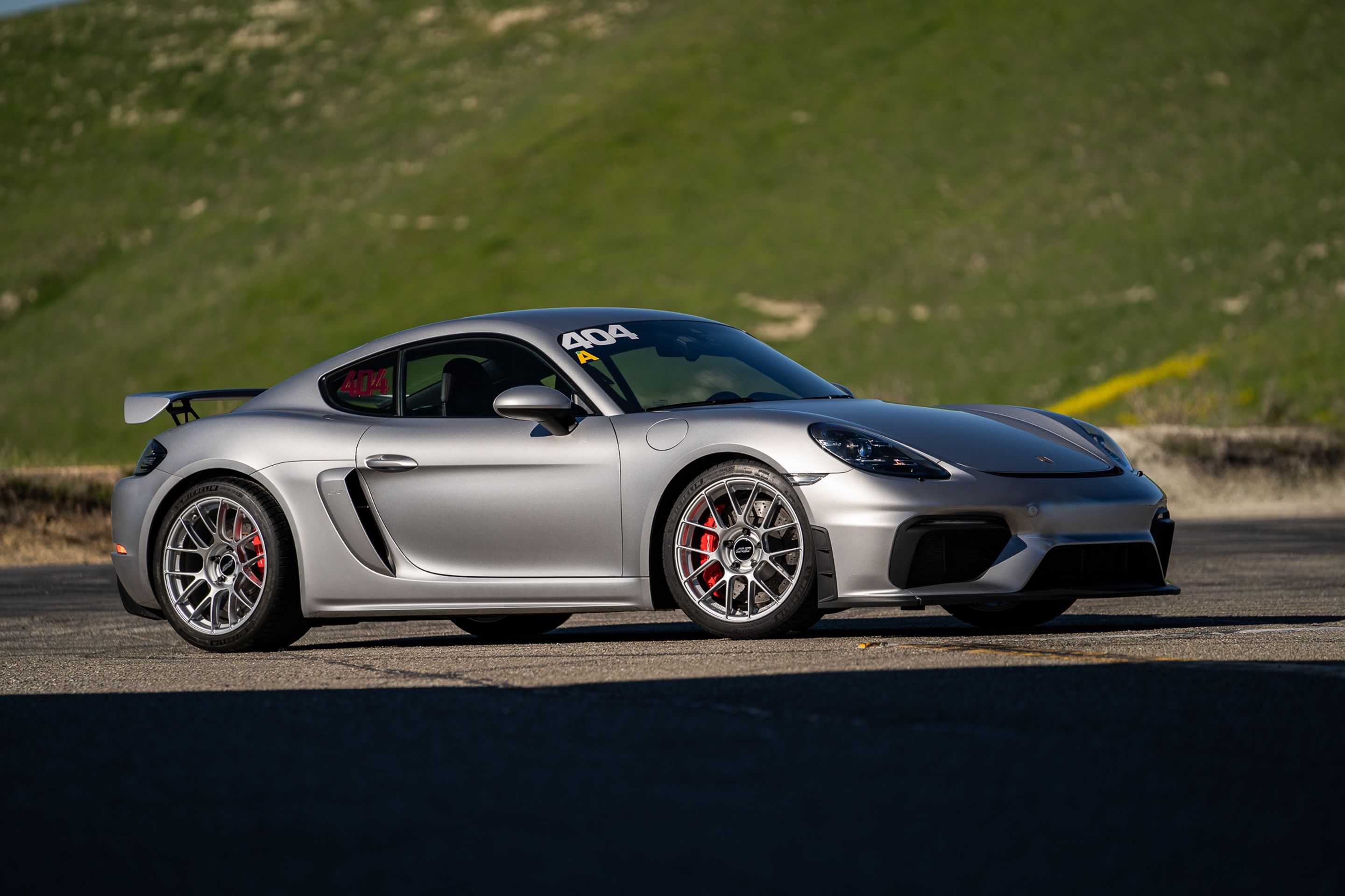 Grey Porsche 718 Cayman GT4 with 19" EC-7RS Apex wheels in Race Silver