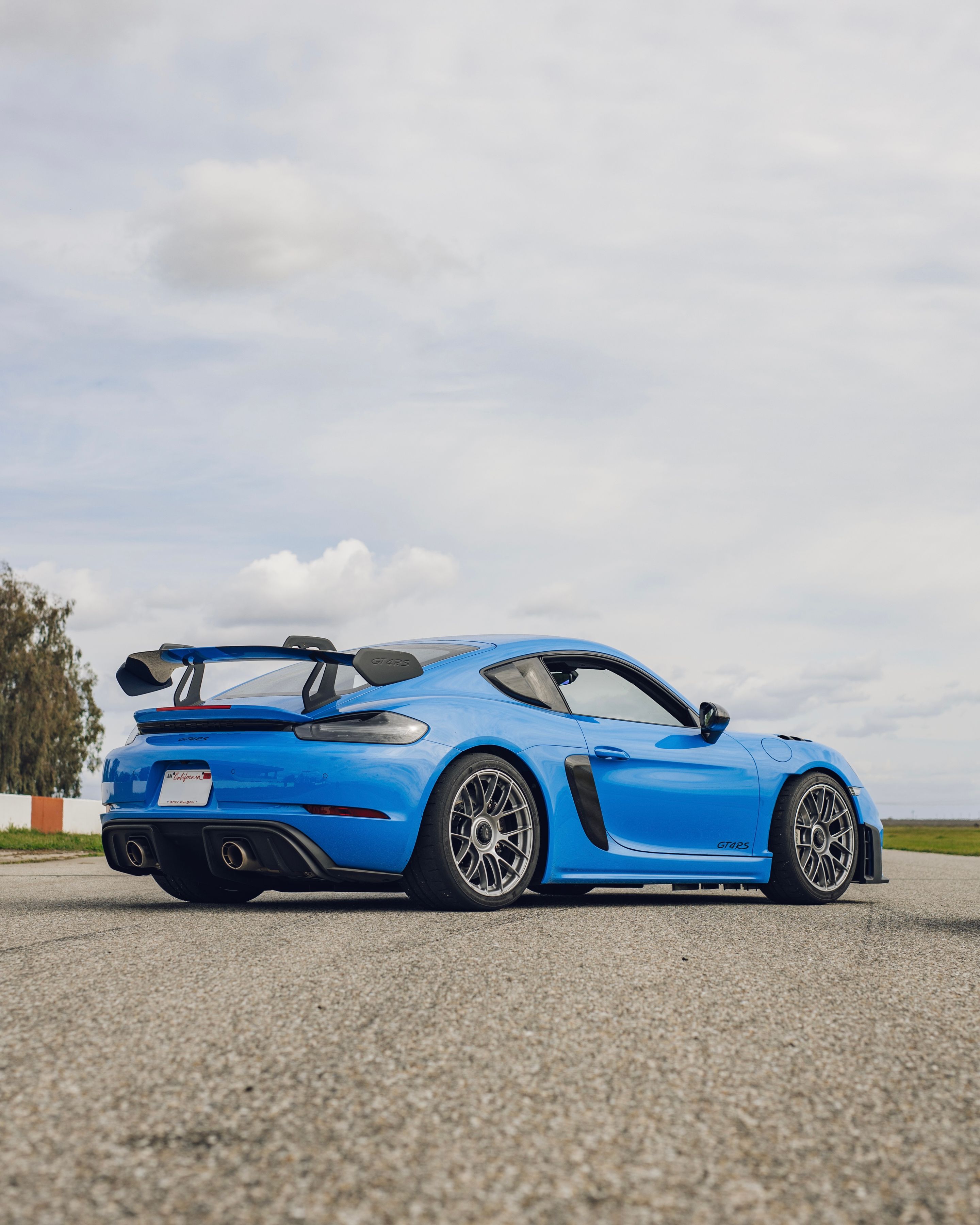 Blue Porsche 718 Cayman GT4 RS with 19" EC-7RS Apex wheels in Race Silver