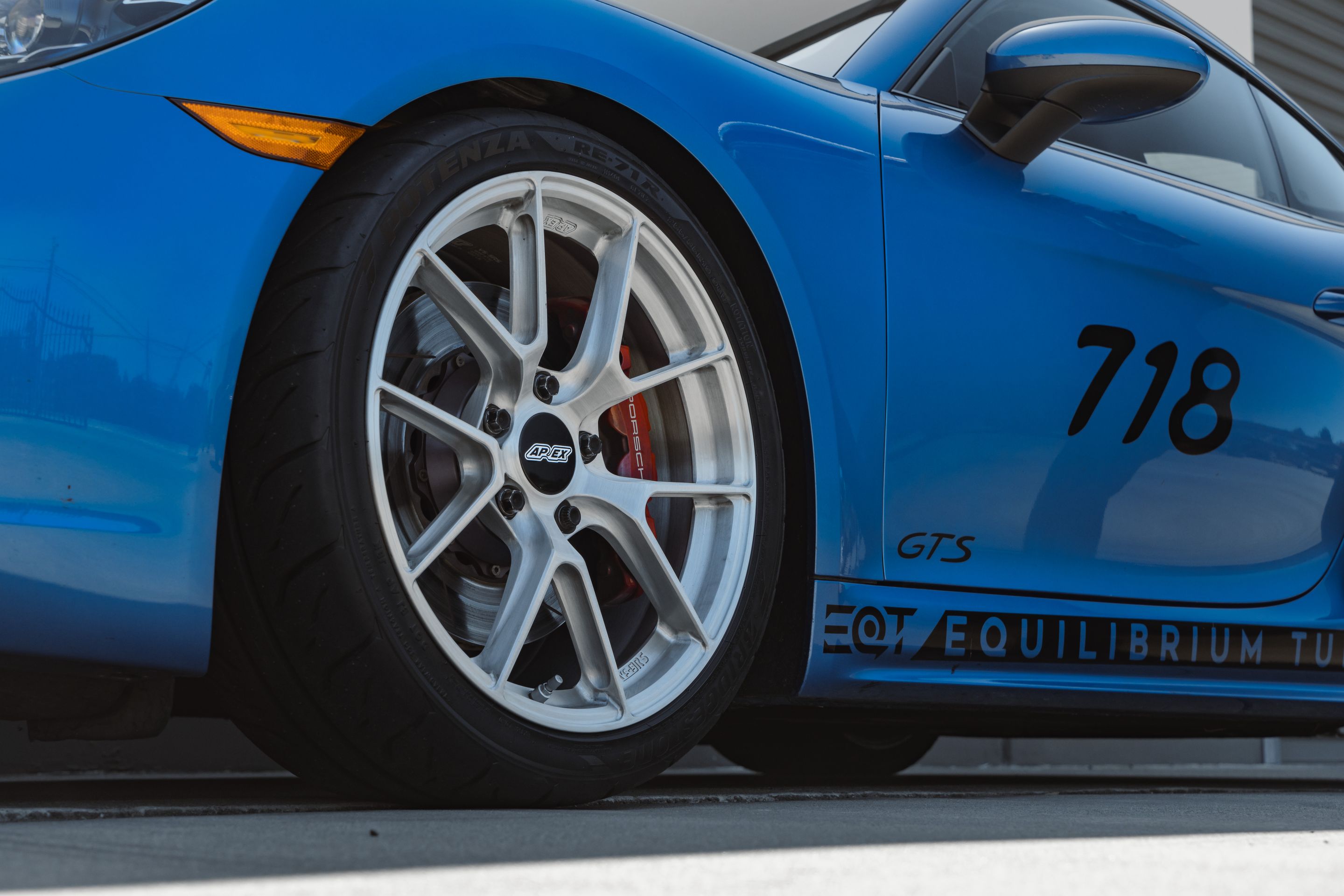 Blue Porsche 718 Cayman GTS 2.5L with 19" VS-5RS Apex wheels in Brushed Clear