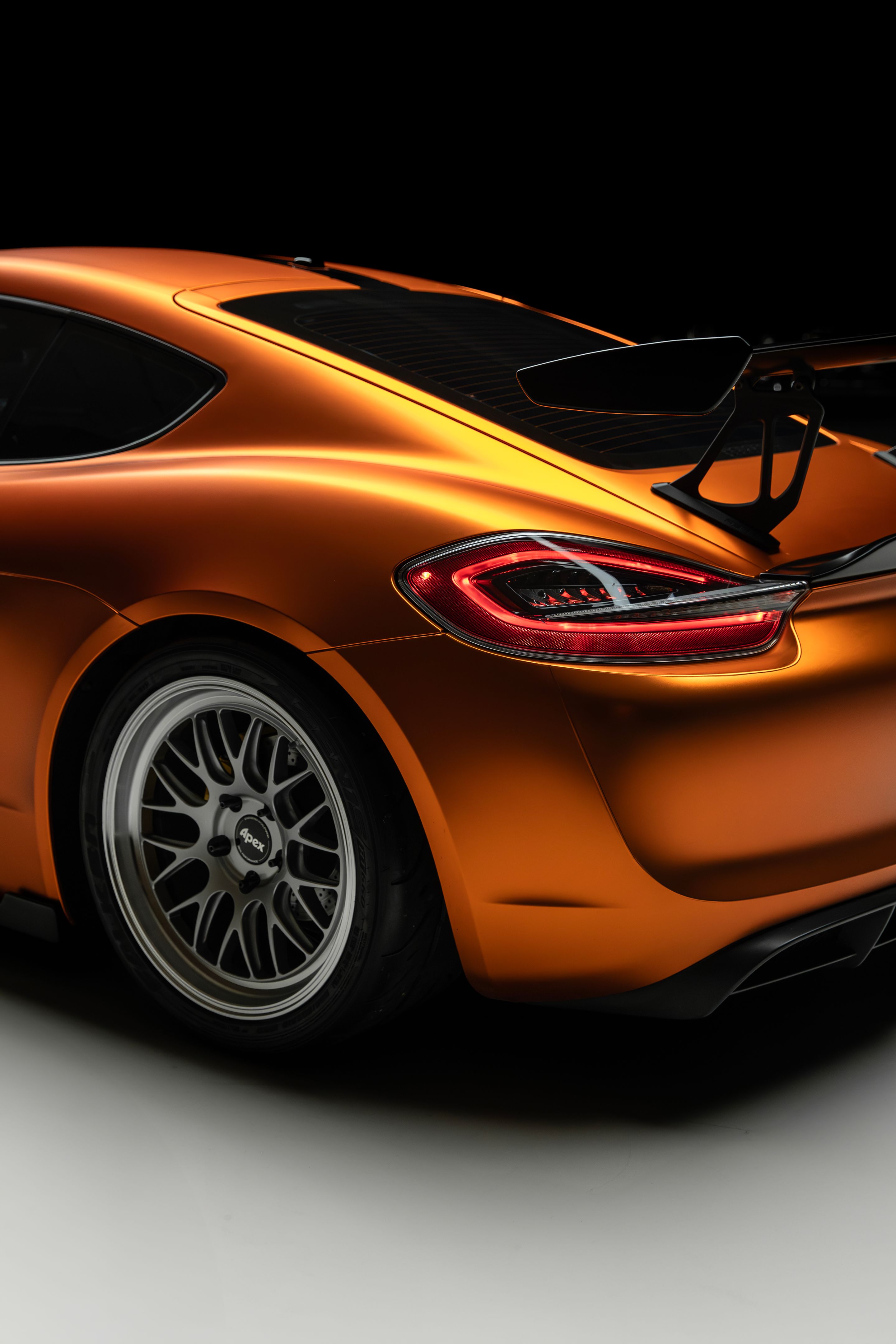 Orange Porsche 981 Cayman GT4 with 19" ML-10RT Apex wheels in Machined Lip Race Silver