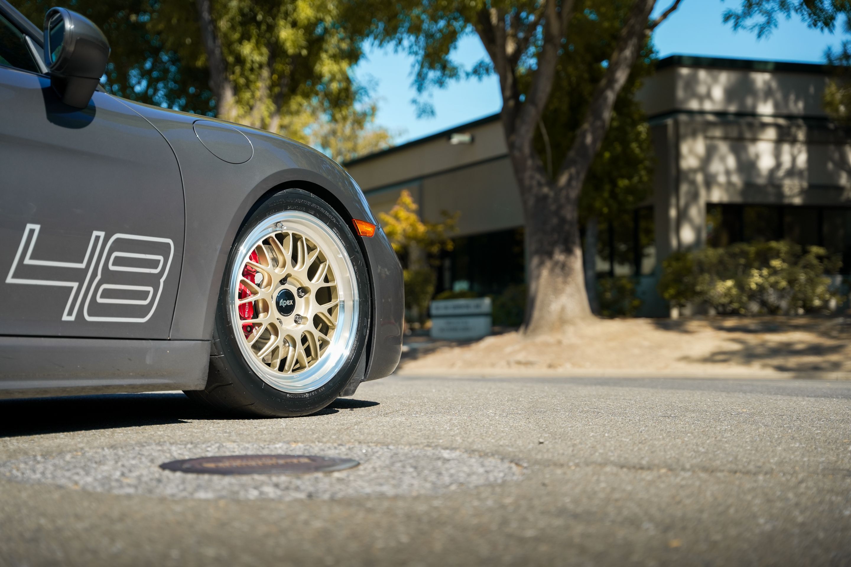 Grey Porsche 718 Cayman S with 18" ML-10RT Apex wheels in Machined Lip Gloss Motorsport Gold