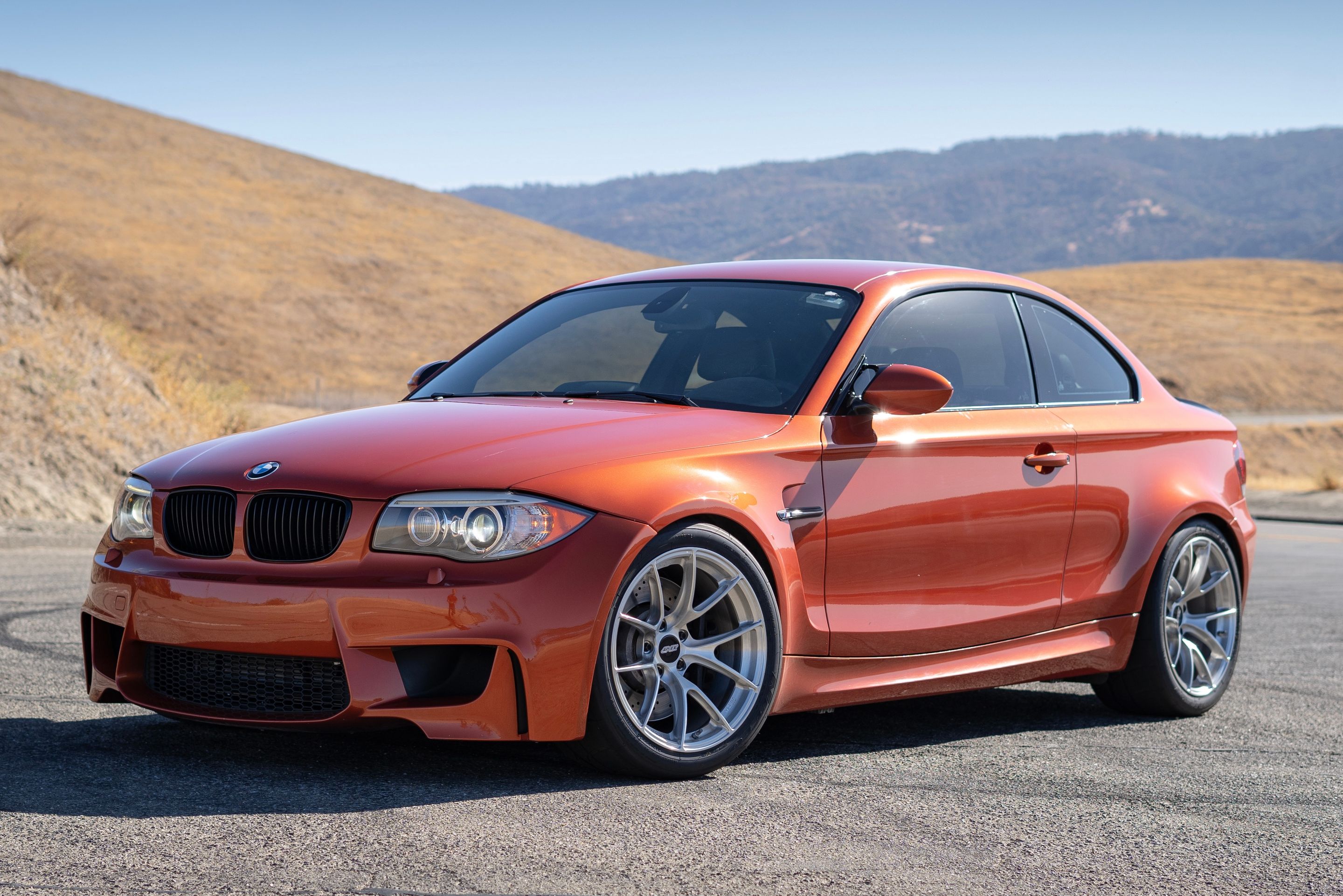 Orange BMW E82 1M with 18" VS-5RS Apex wheels in Brushed Clear