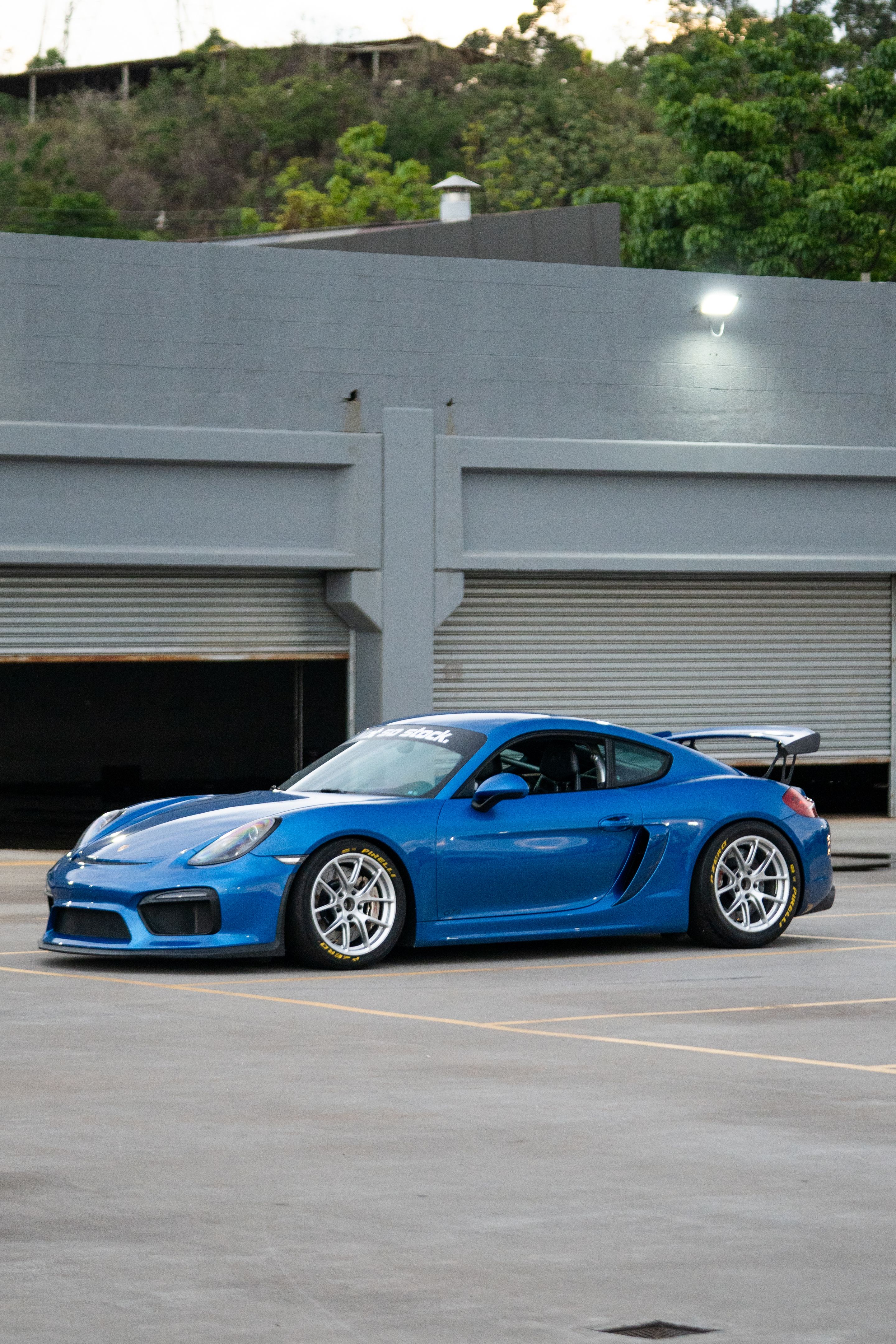 Blue Porsche 981 Cayman GT4 with 18" VS-5RE Apex wheels in Race Silver