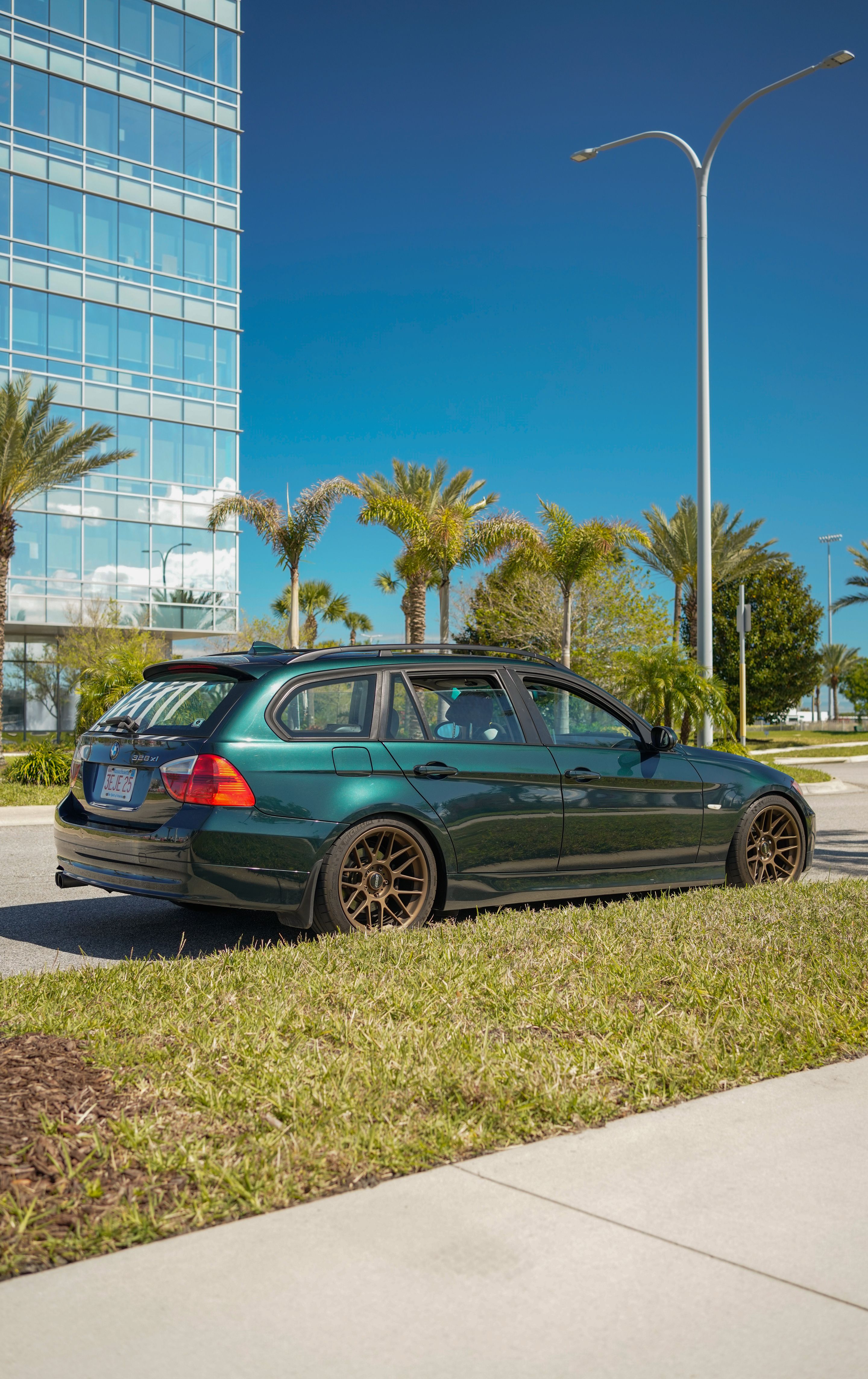Green BMW E91 Wagon 3 Series with 18" ARC-8 Apex wheels in Satin Bronze