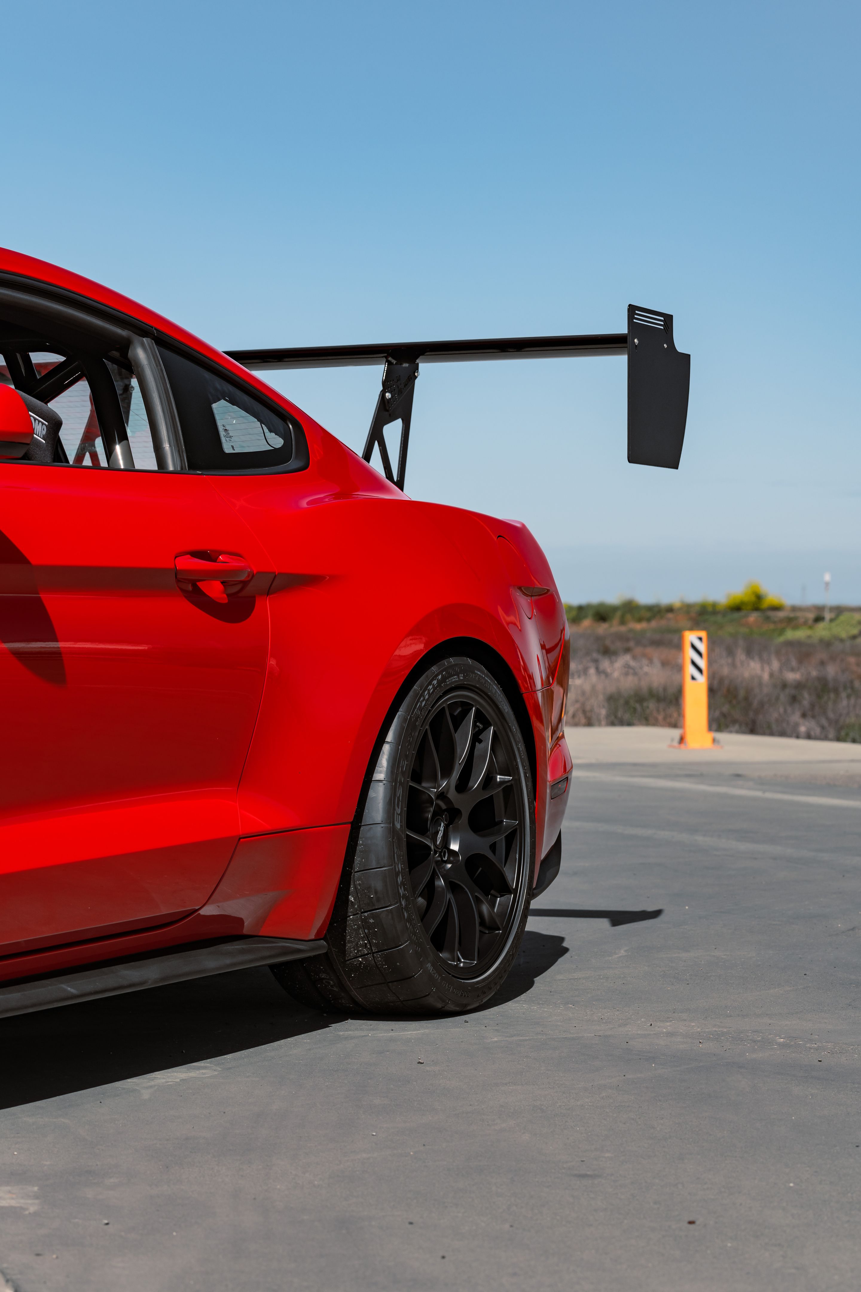 Red Ford S550 Mustang GT with 19" EC-7 Apex wheels in Satin Black