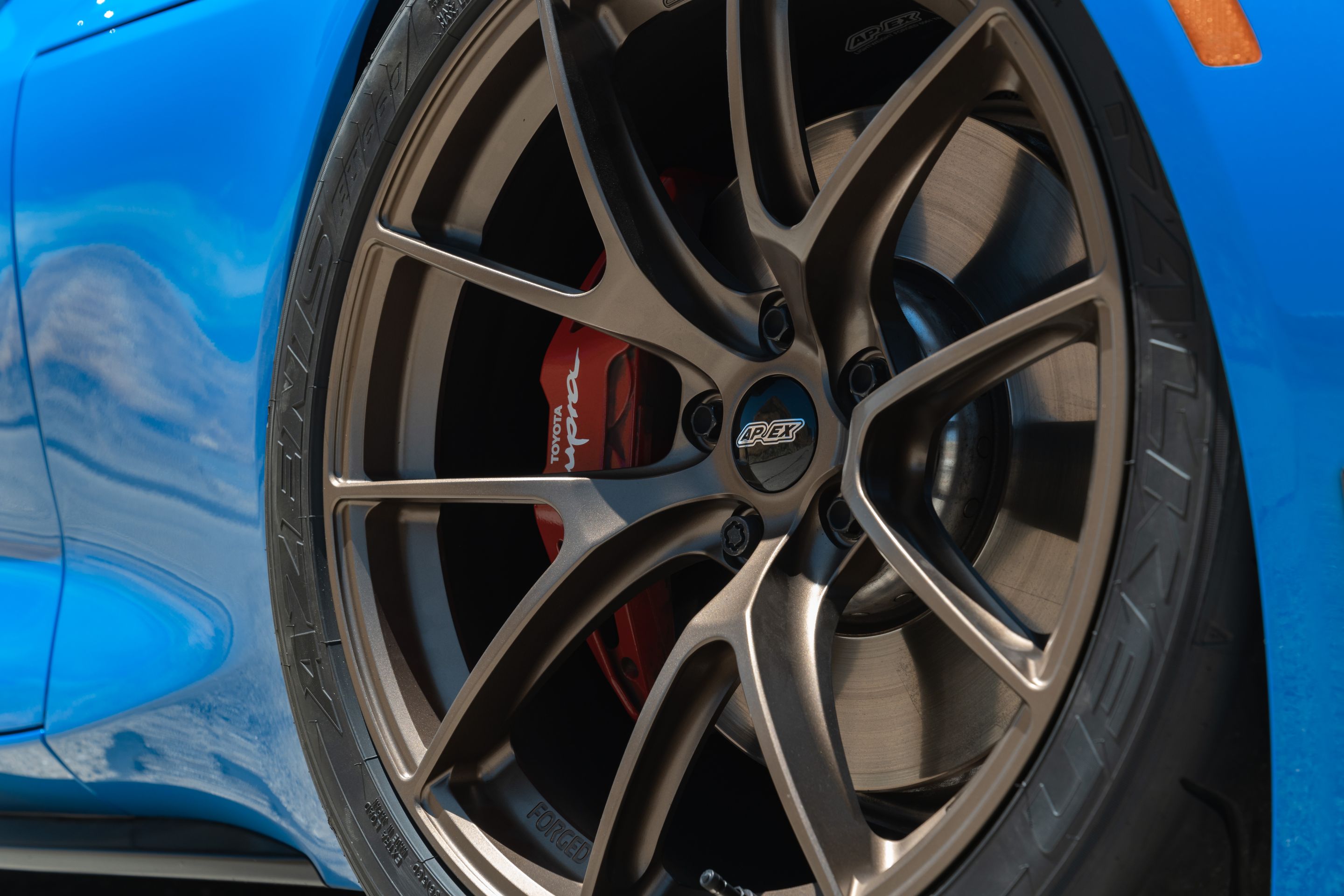 Blue Toyota GR Supra with 19" VS-5RS Apex wheels in Satin Bronze