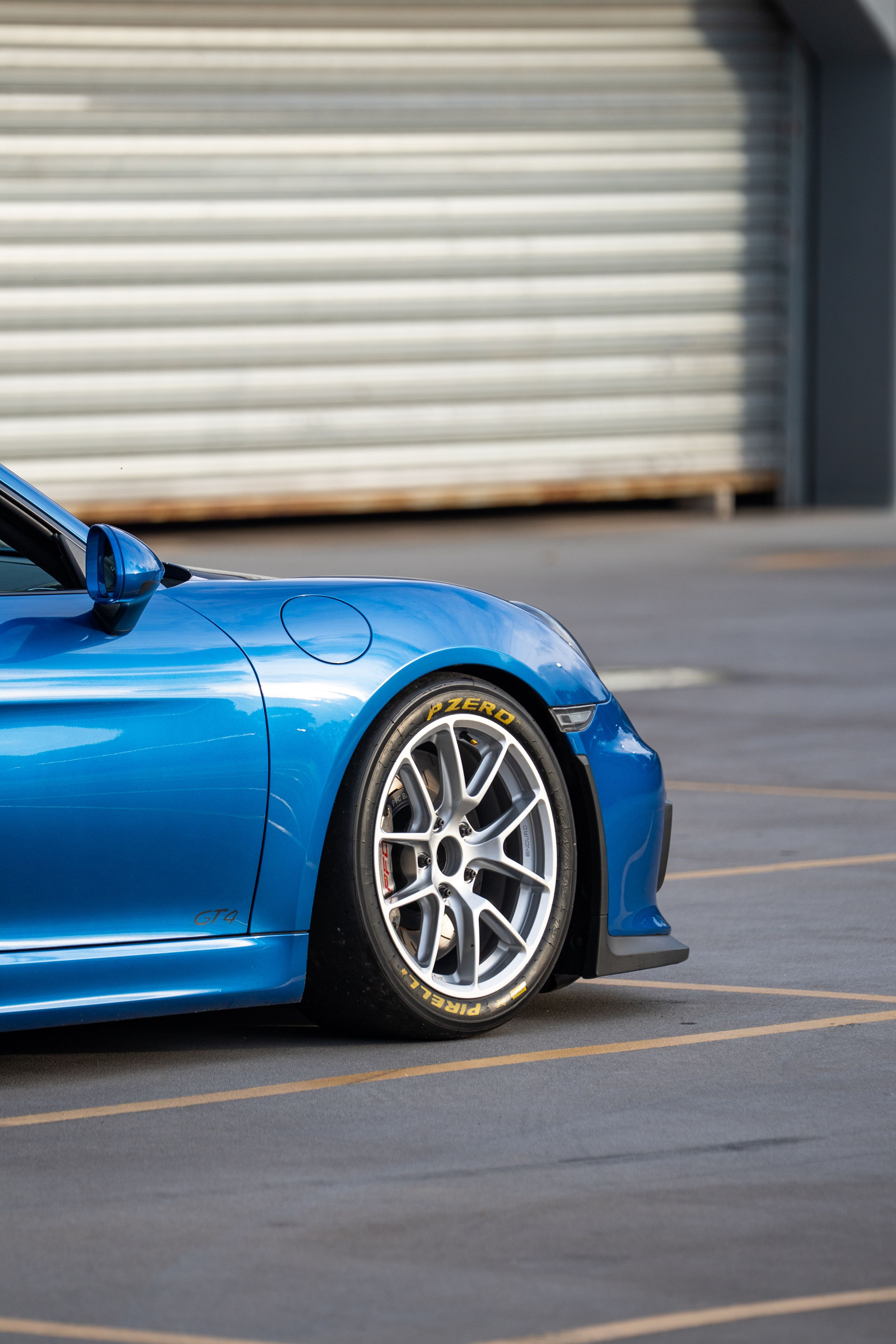 Blue Porsche 981 Cayman GT4 with 18" VS-5RE Apex wheels in Race Silver
