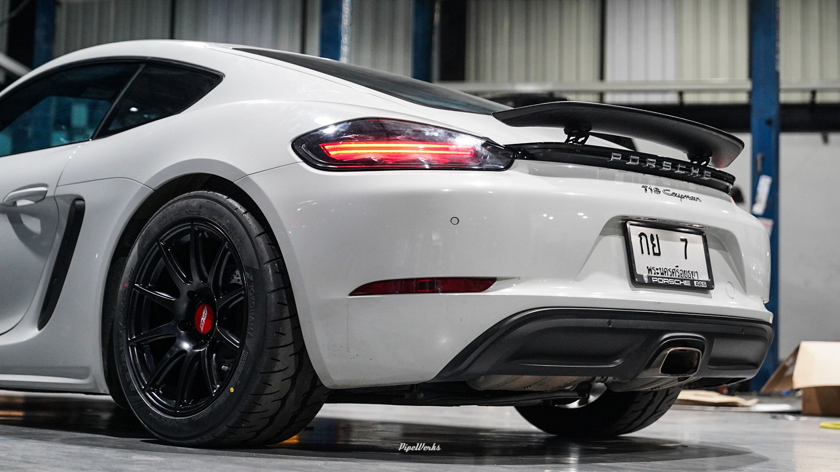 White Porsche 718 Cayman Base with 18" SM-10 Apex wheels in Satin Black