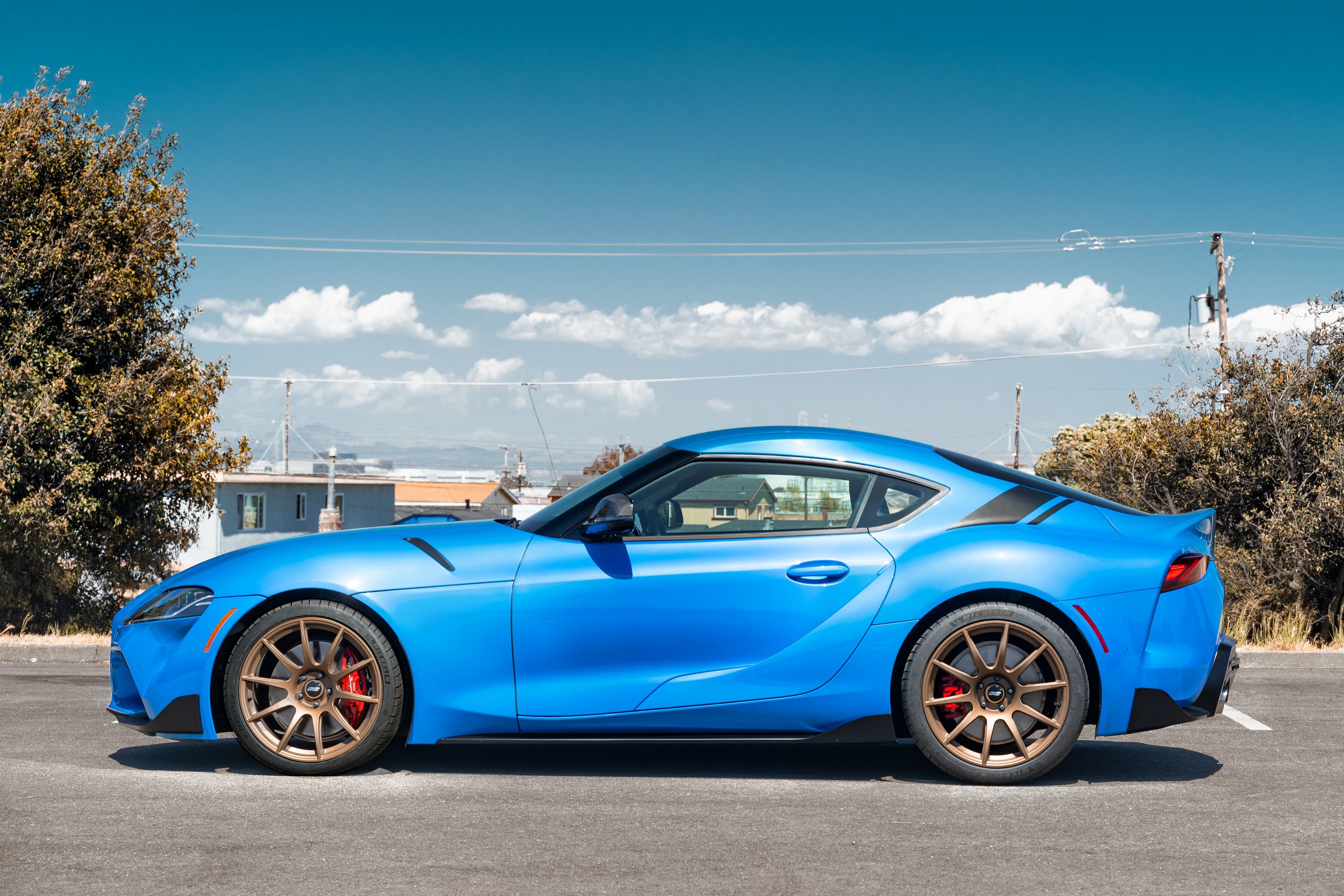 Blue Toyota GR Supra with 19" SM-10 Apex wheels in Satin Bronze