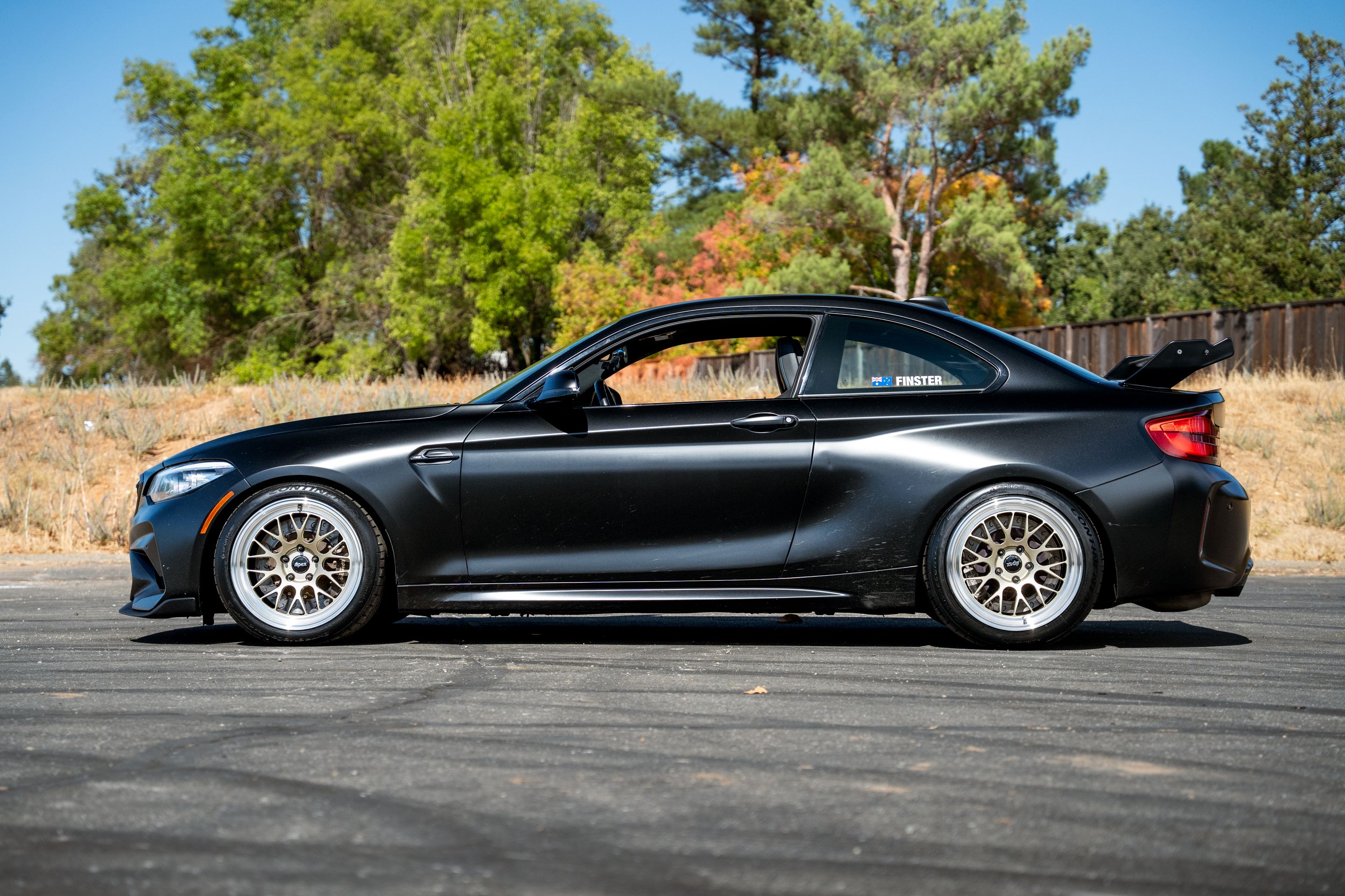 Black BMW F87 M2 with 18" ML-10RT Apex wheels in Machined Lip Gloss Motorsport Gold