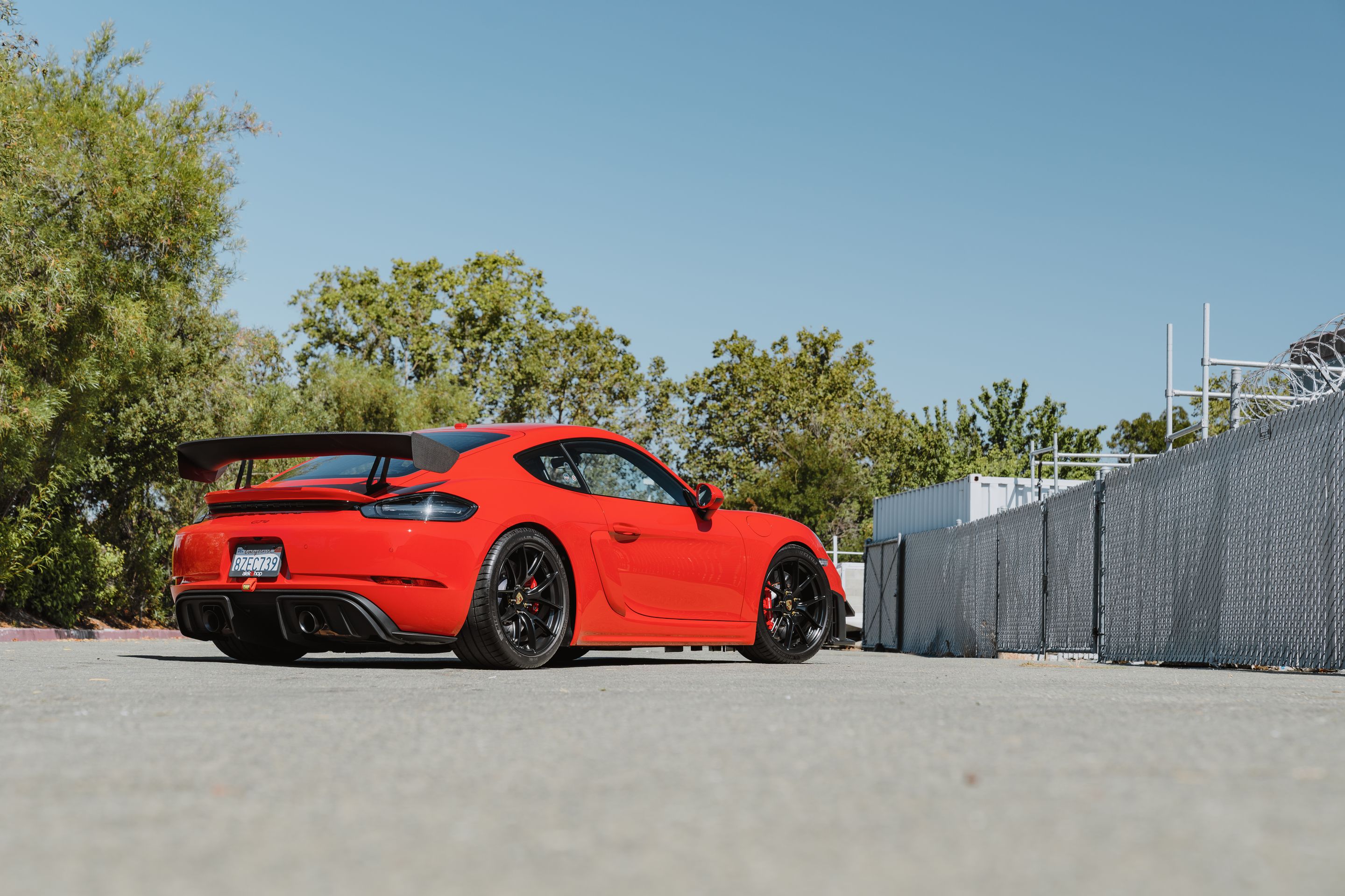 Red Porsche 718 Cayman GT4 with 19" VS-5RS Apex wheels in Satin Black