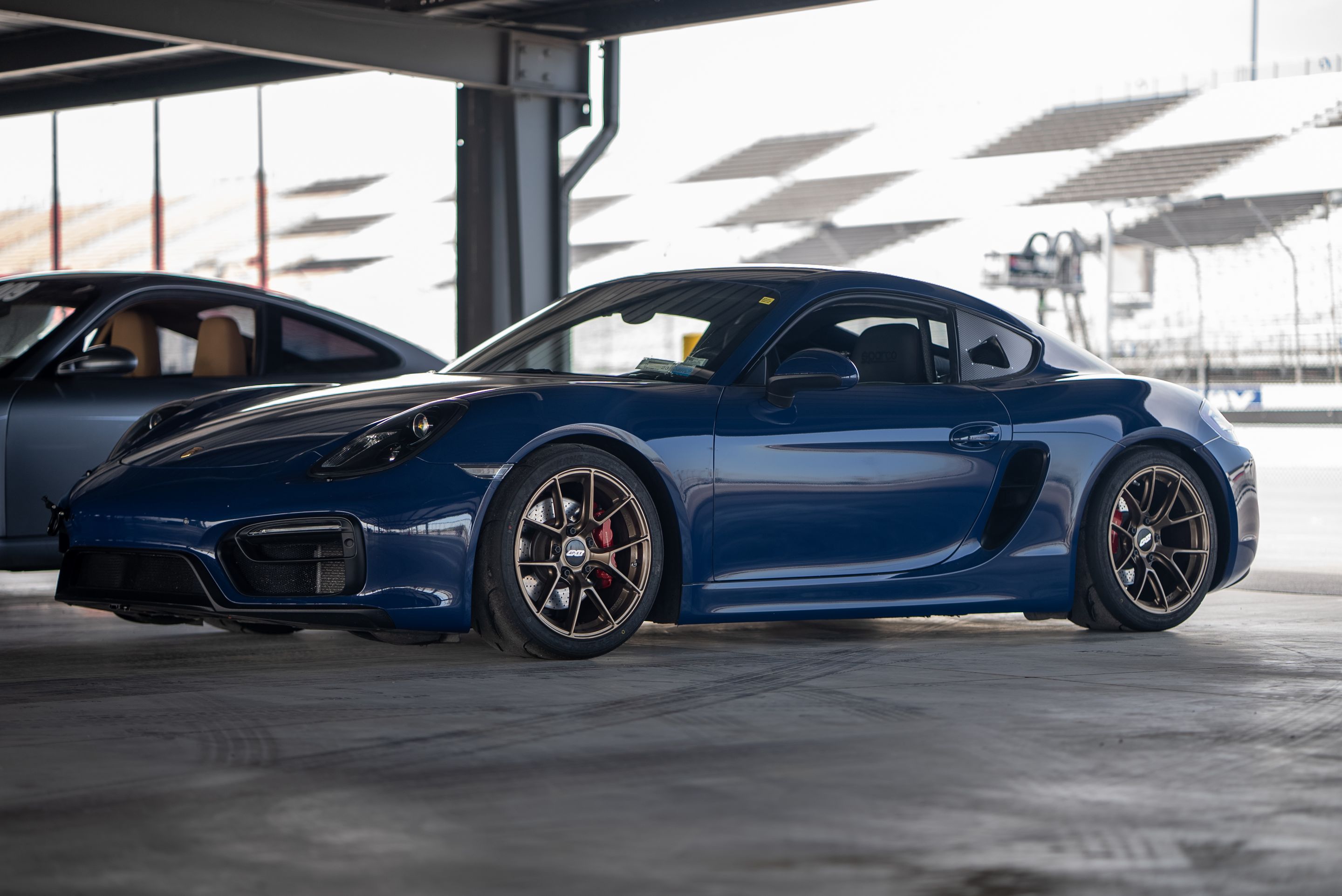 Blue Porsche 981 Cayman GTS with 18" VS-5RS Apex wheels in Satin Bronze