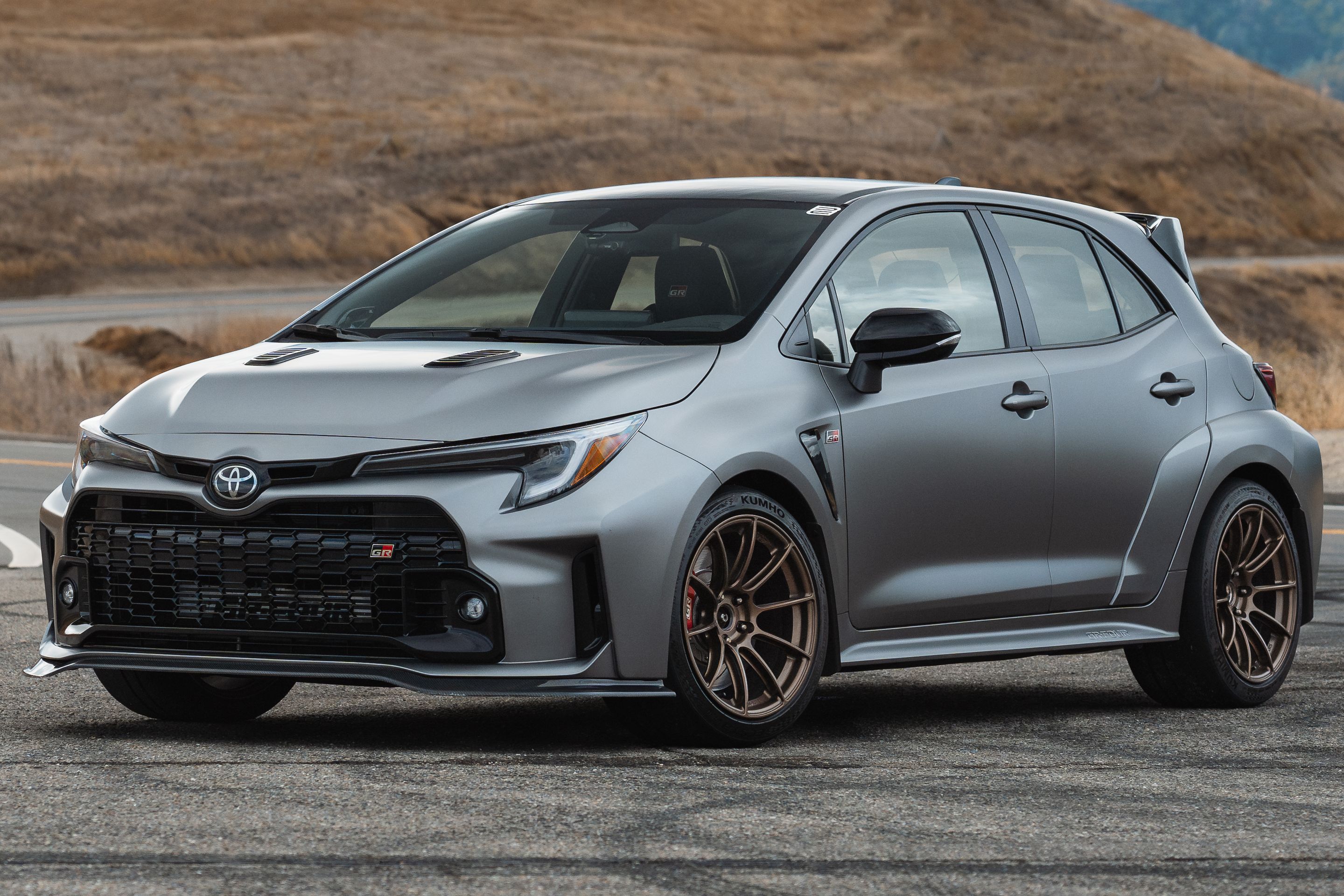 Grey Toyota GR Corolla with 18" SM-10RS Apex wheels in Satin Bronze