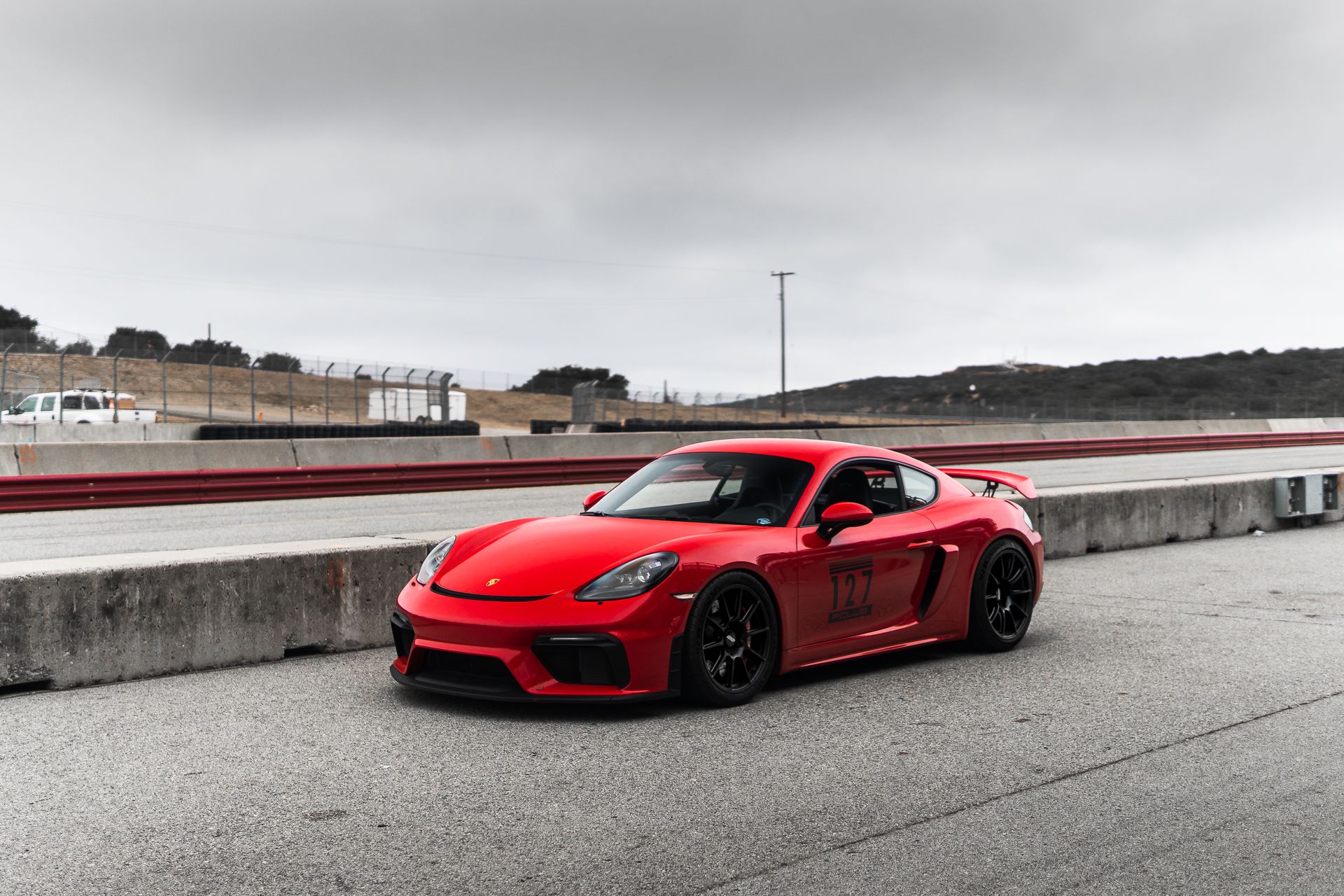 Red Porsche 718 Cayman GT4 with 19" SM-10 Apex wheels in Satin Black