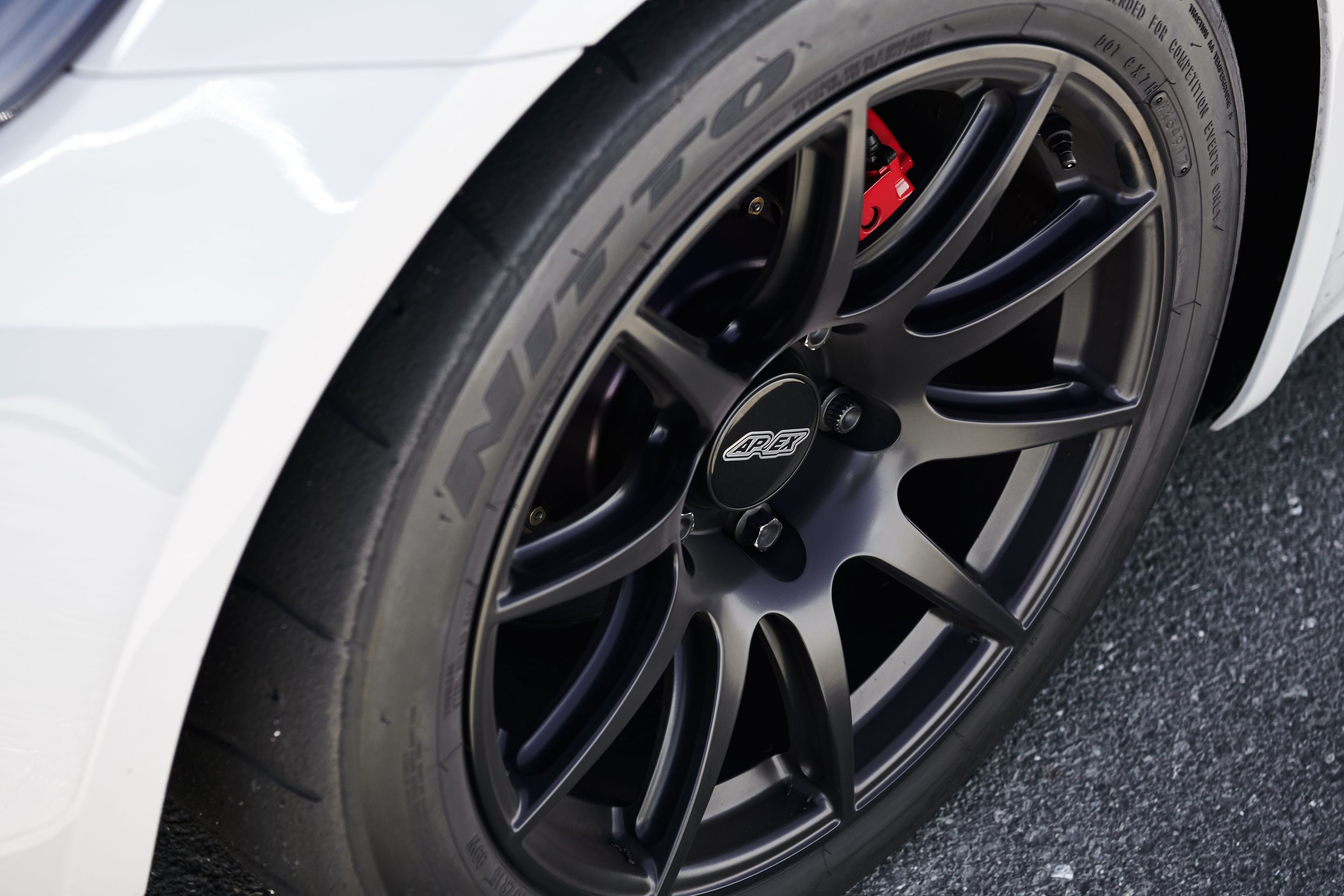 White Porsche 718 Cayman S with 18" SM-10 Apex wheels in Satin Black