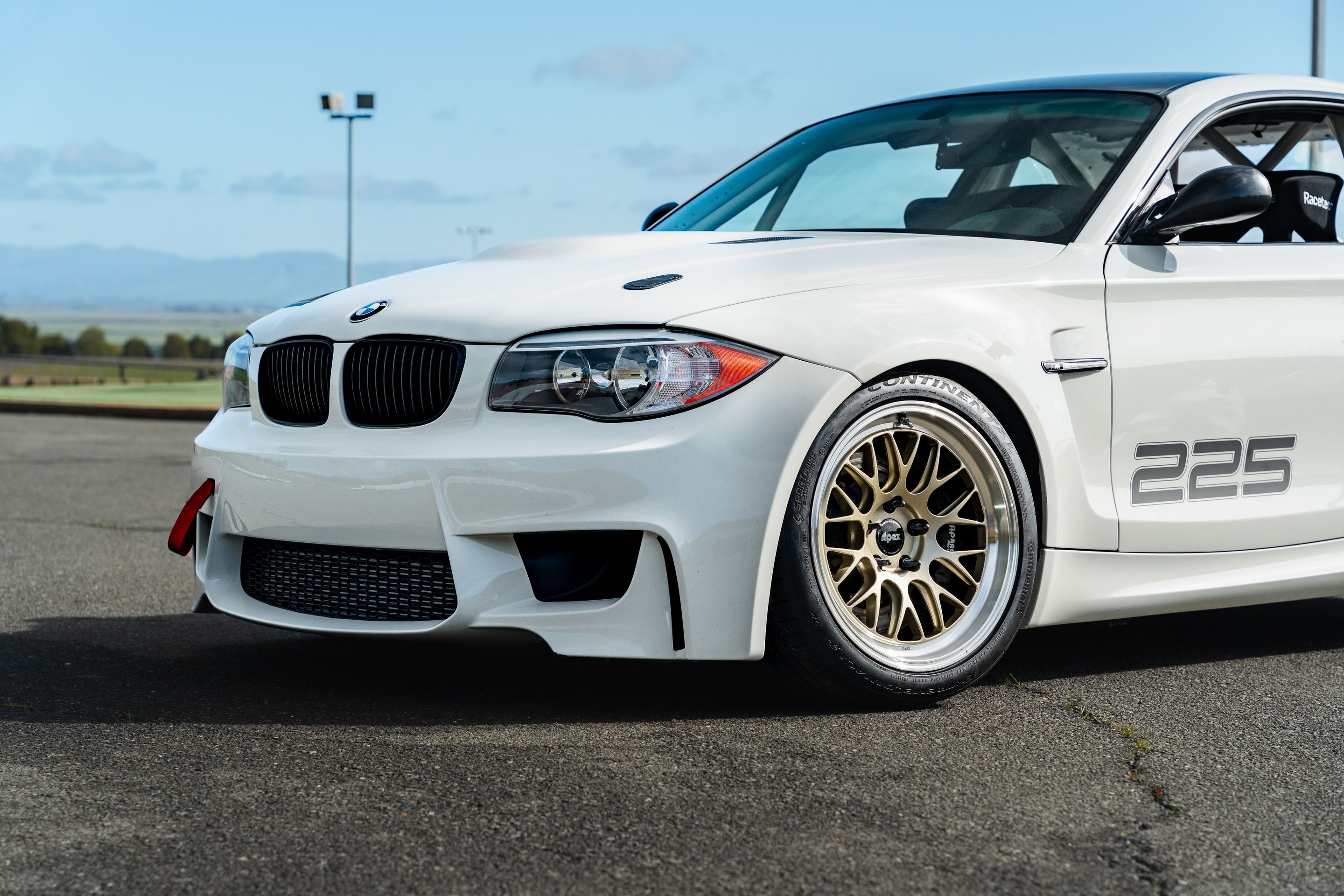 White BMW E82 1M with 18" ML-10RT Apex wheels in Machined Lip Gloss Motorsport Gold