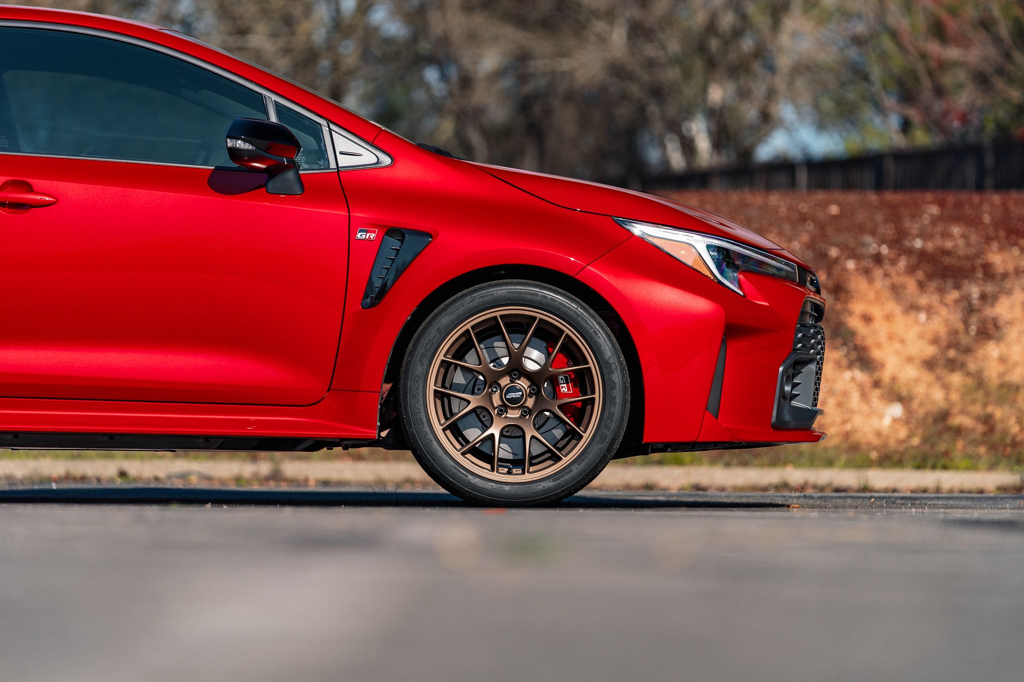 Red Toyota GR Corolla with 18" EC-7 Apex wheels in Satin Bronze