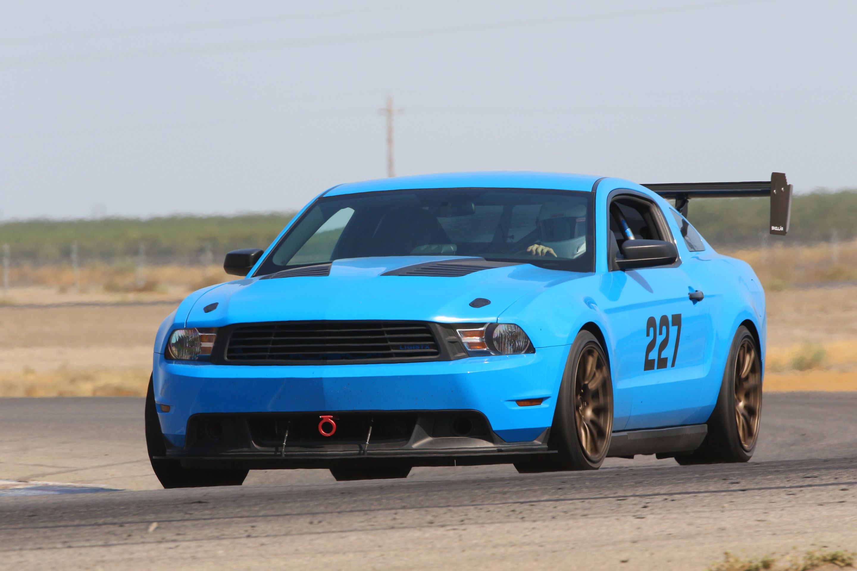 Blue Ford S197 Mustang V6 with 18" SM-10 Apex wheels in Satin Bronze