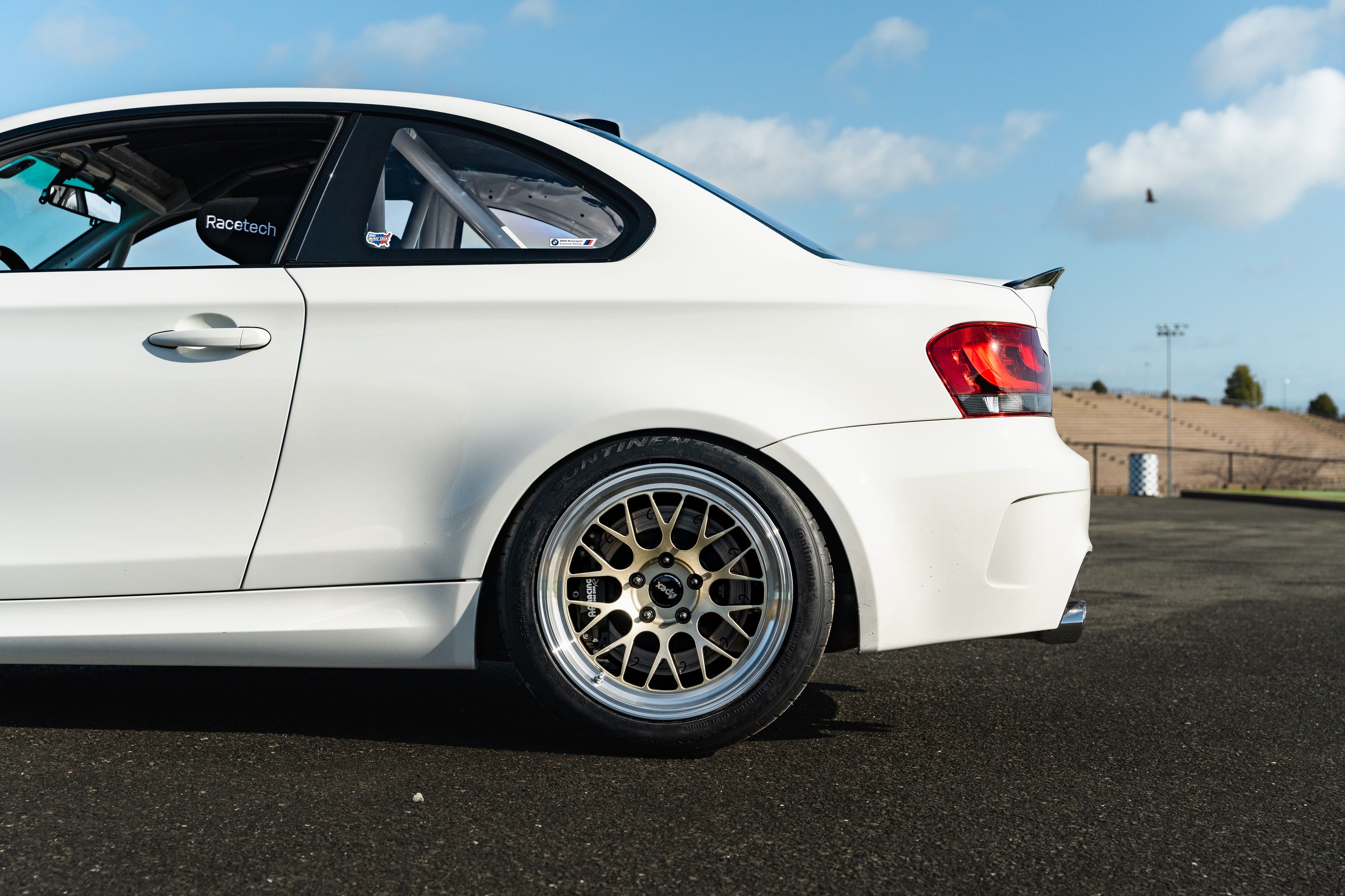 White BMW E82 1M with 18" ML-10RT Apex wheels in Machined Lip Gloss Motorsport Gold