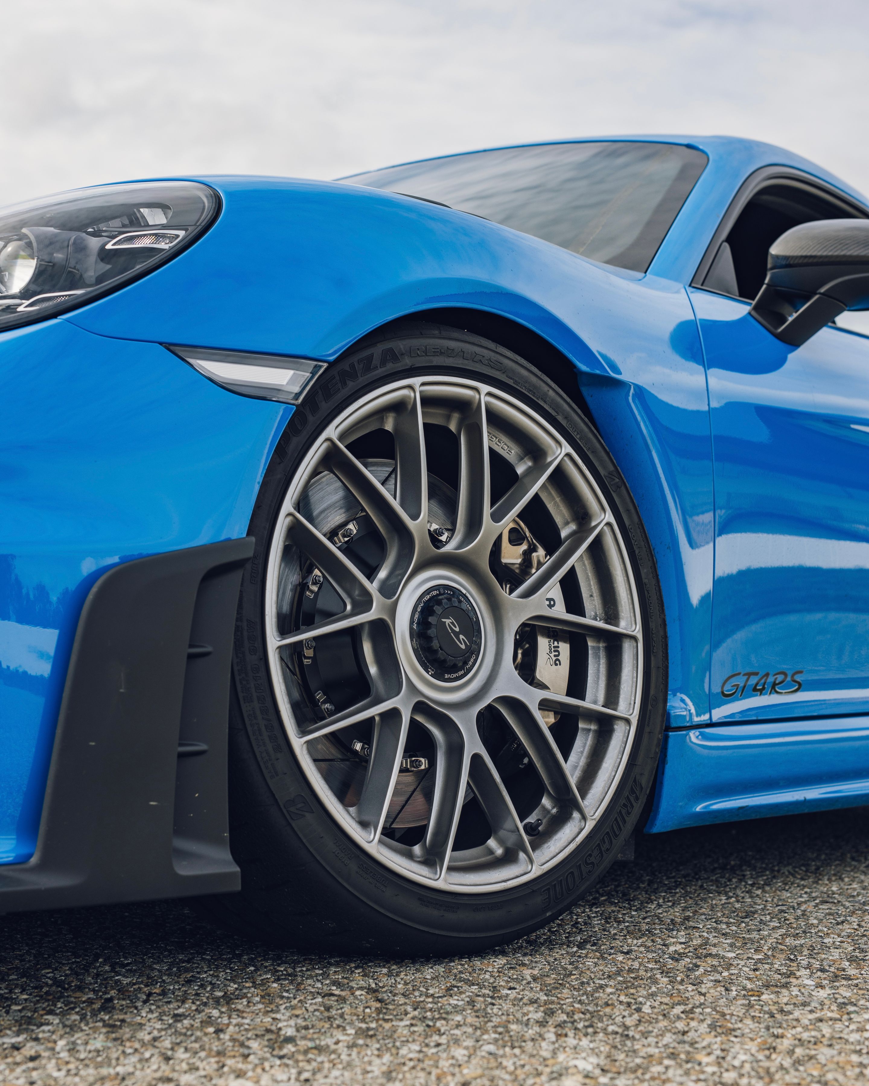 Blue Porsche 718 Cayman GT4 RS with 19" EC-7RS Apex wheels in Race Silver
