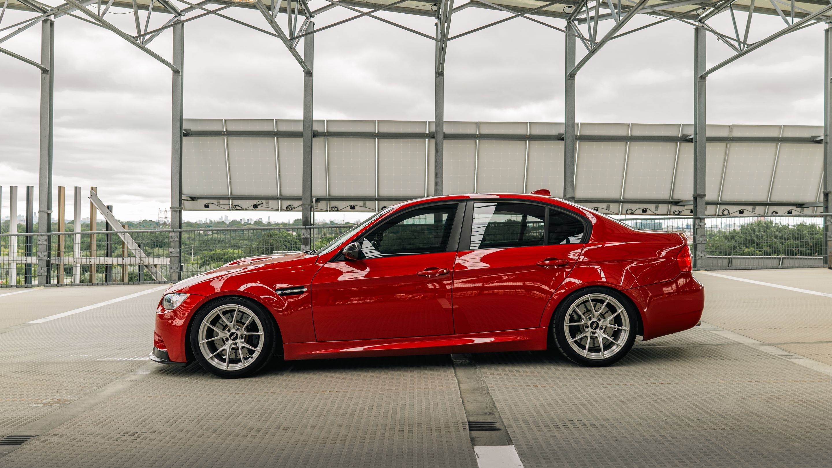 Red BMW E90 Sedan M3 with 18" VS-5RS Apex wheels in Brushed Clear