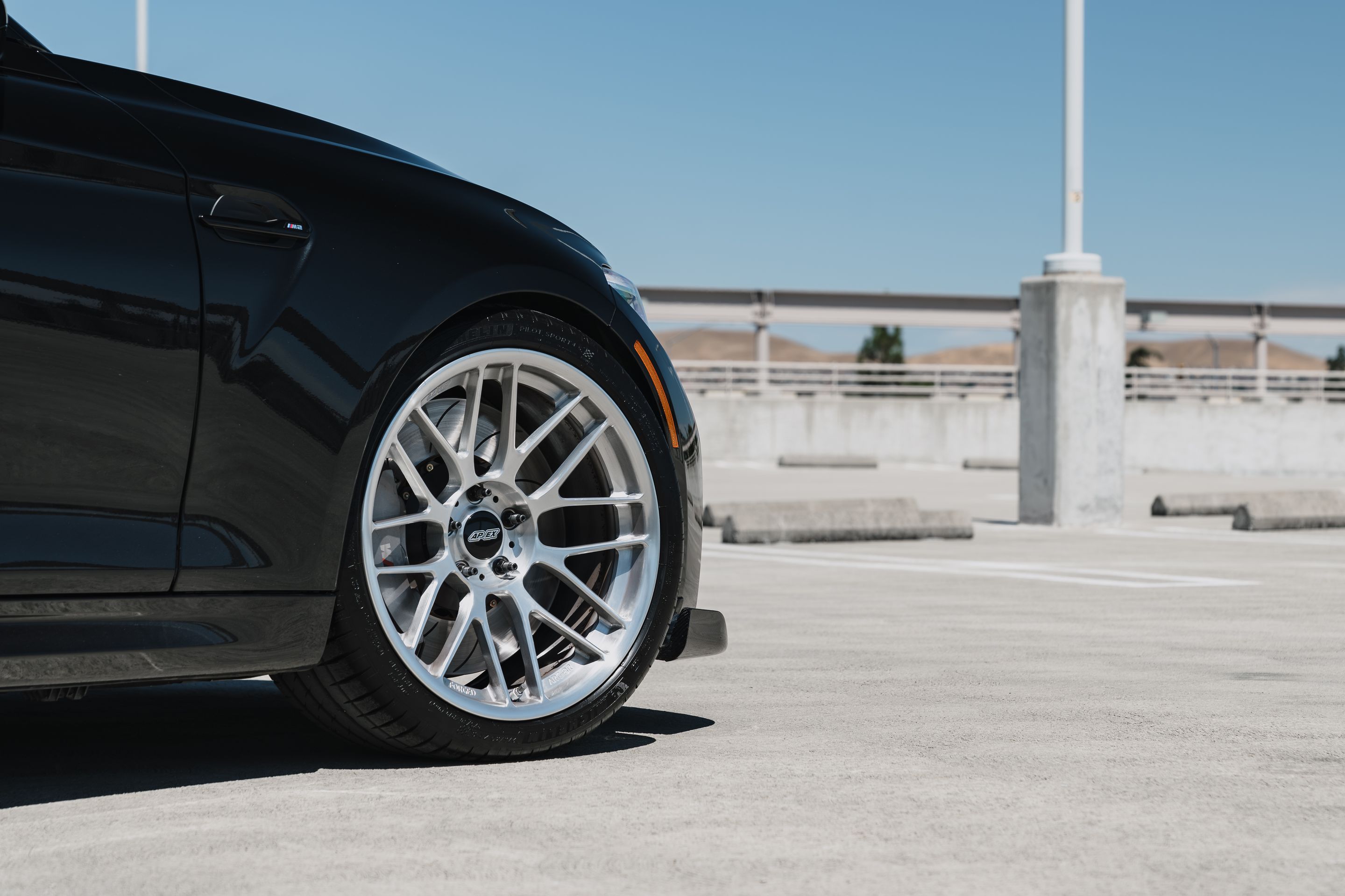 Black BMW F87 M2 with 19" ARC-8RT Apex wheels in Brushed Clear