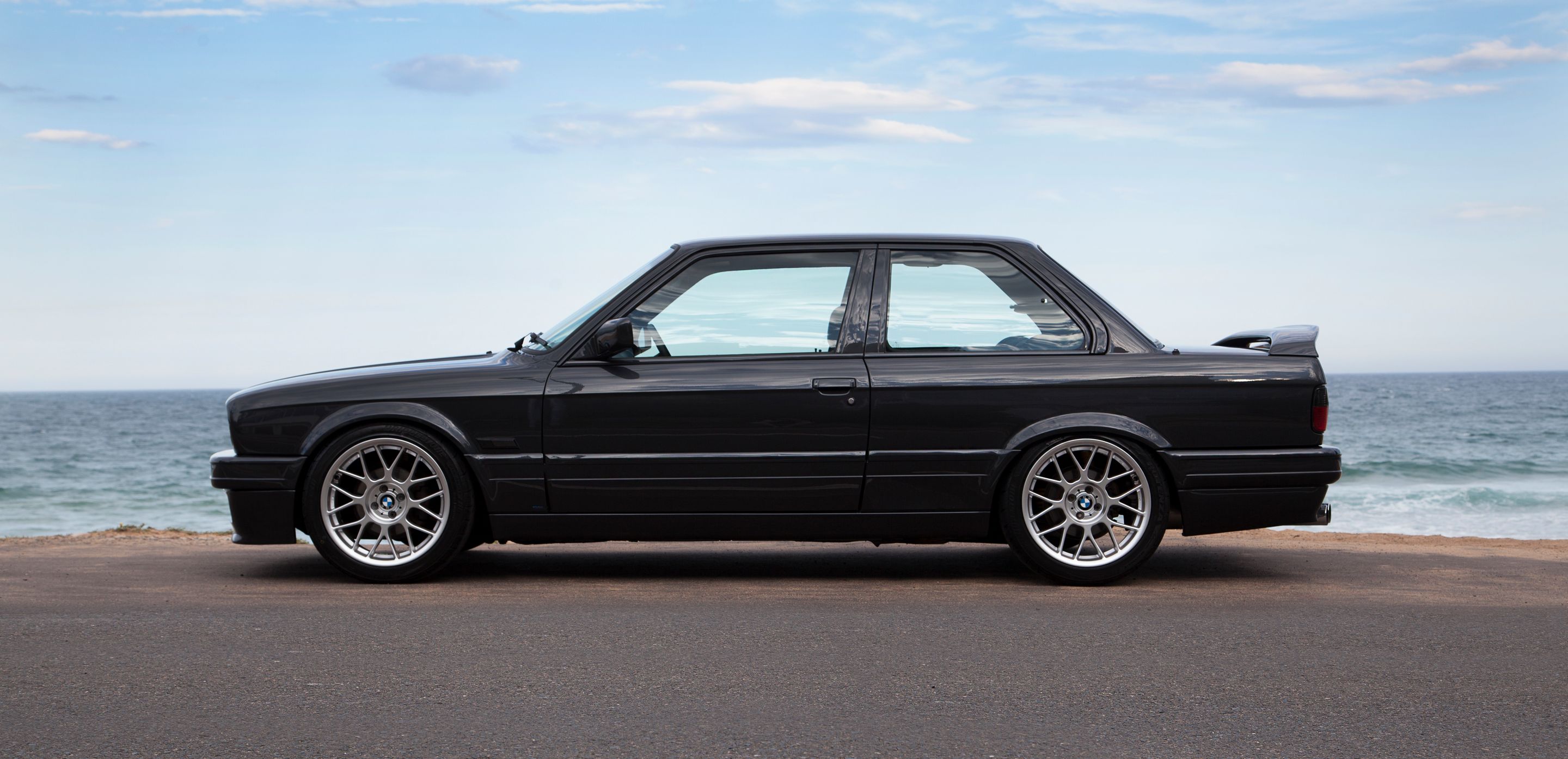Black BMW E30 3 Series with 17" ARC-8 Apex wheels in Hyper Silver