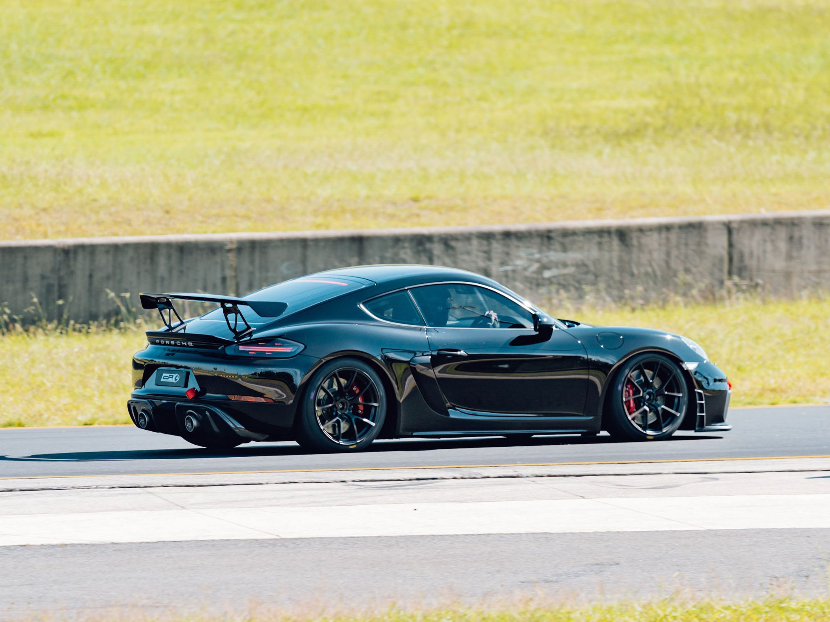 Black Porsche 718 Cayman GT4 with 19" VS-5RS Apex wheels in Satin Black