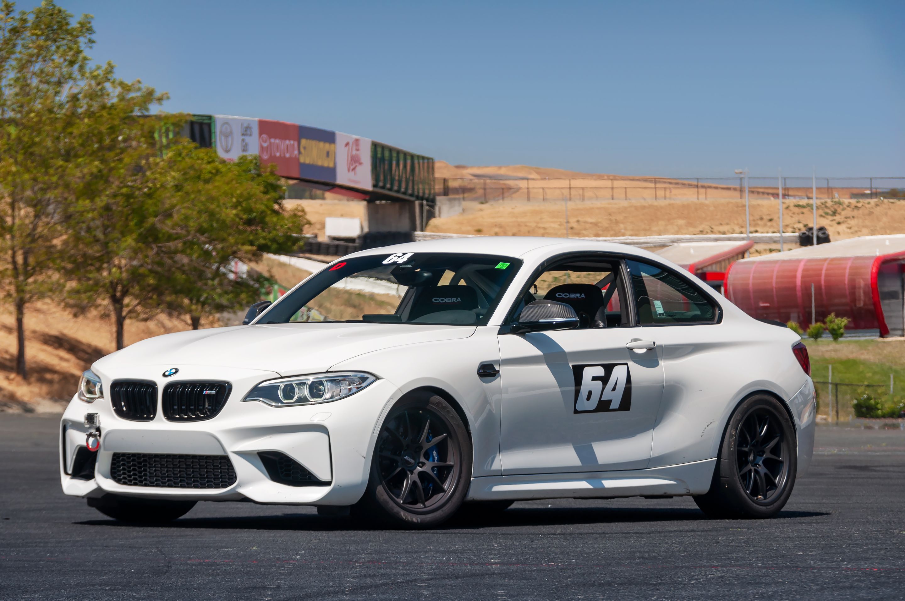 White BMW F87 M2 with 18" FL-5 Apex wheels in Satin Black