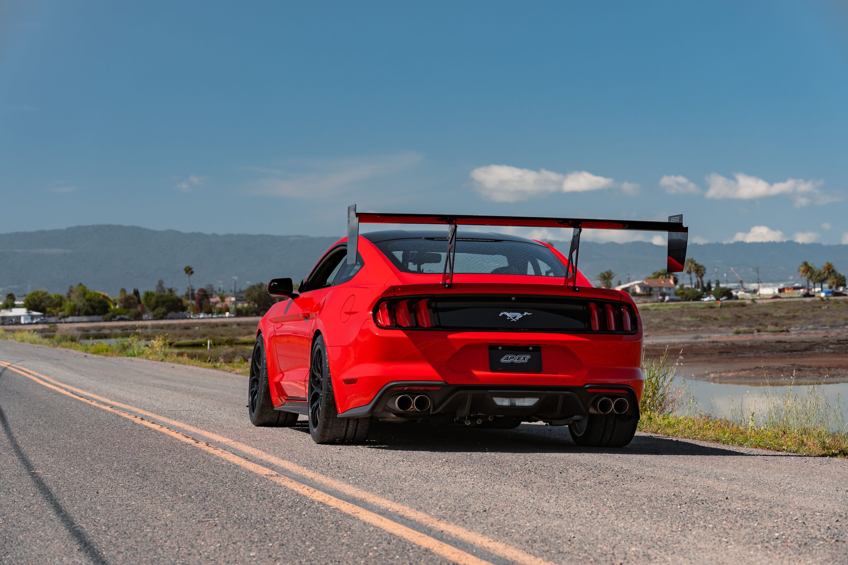 Red Ford S550 Mustang GT with 19" EC-7 Apex wheels in Satin Black