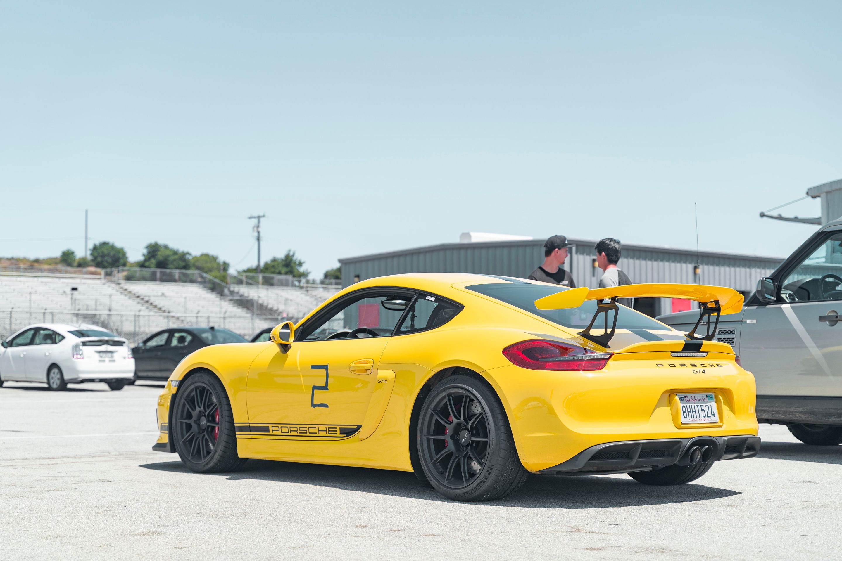 Yellow Porsche 981 Cayman GT4 with 19" SM-10 Apex wheels in Satin Black