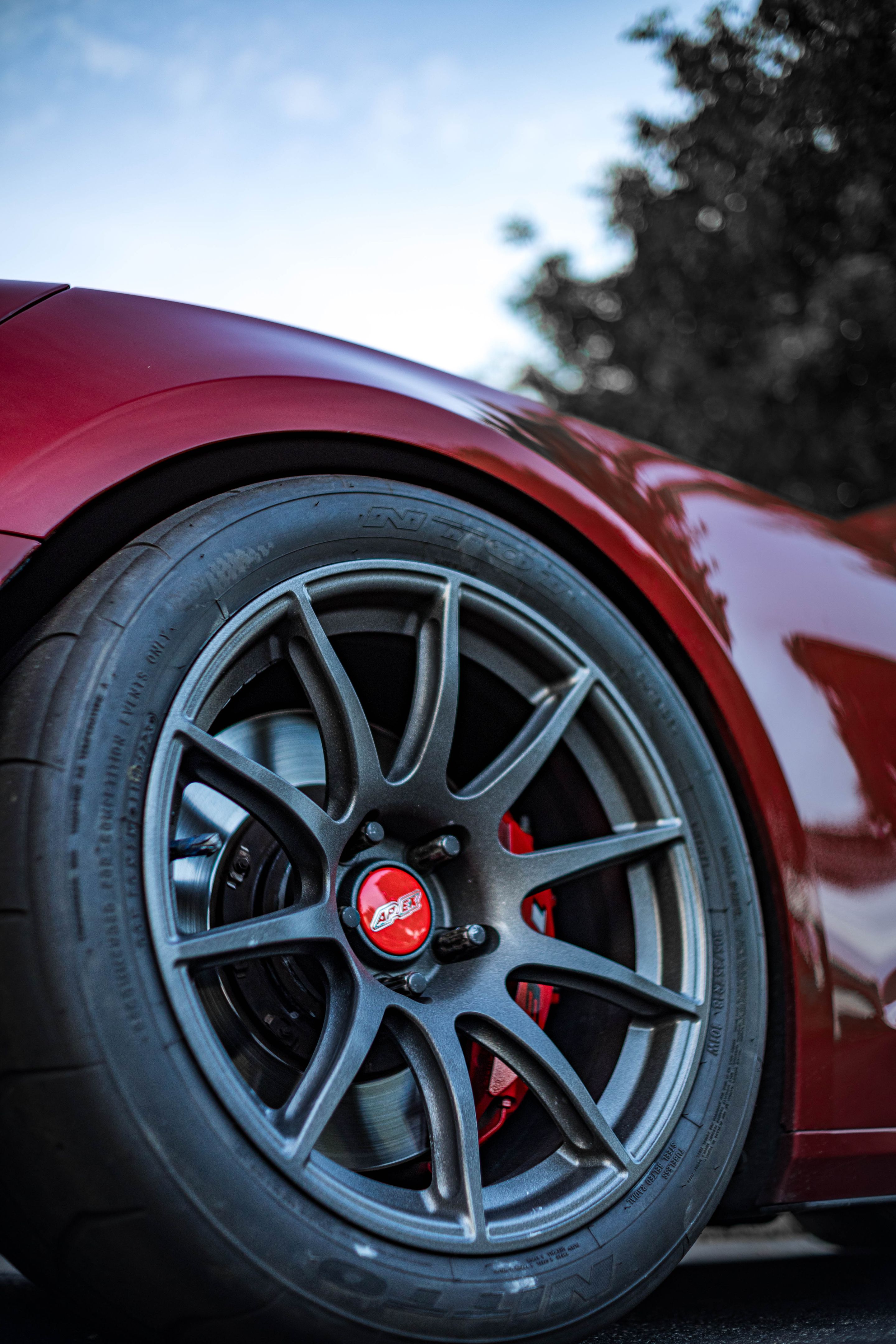 Red Chevrolet 6th Gen Camaro SS with 19" SM-10 Apex wheels in Satin Black