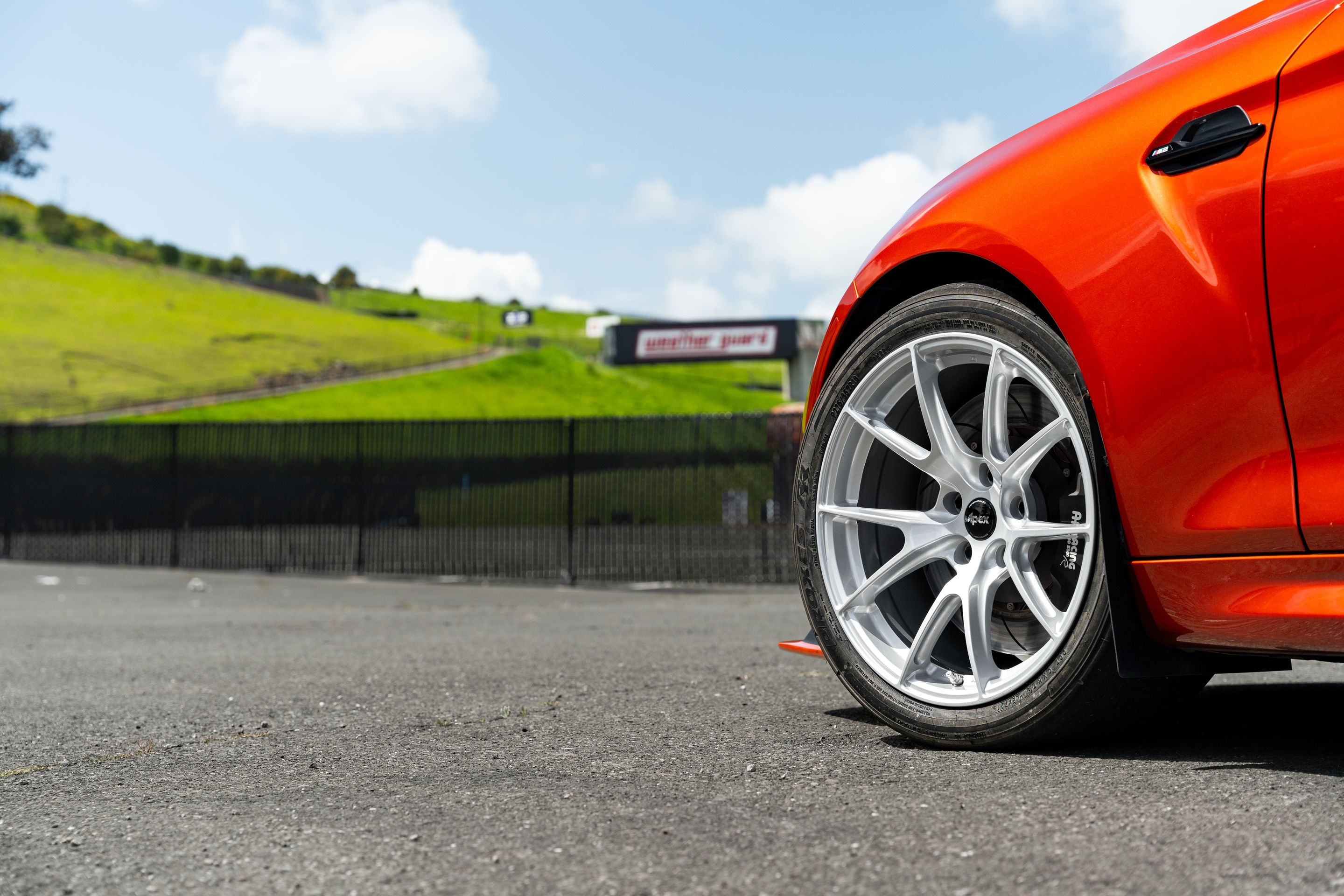 Orange BMW F87 M2 with 18" VS-5 Apex wheels in Race Silver