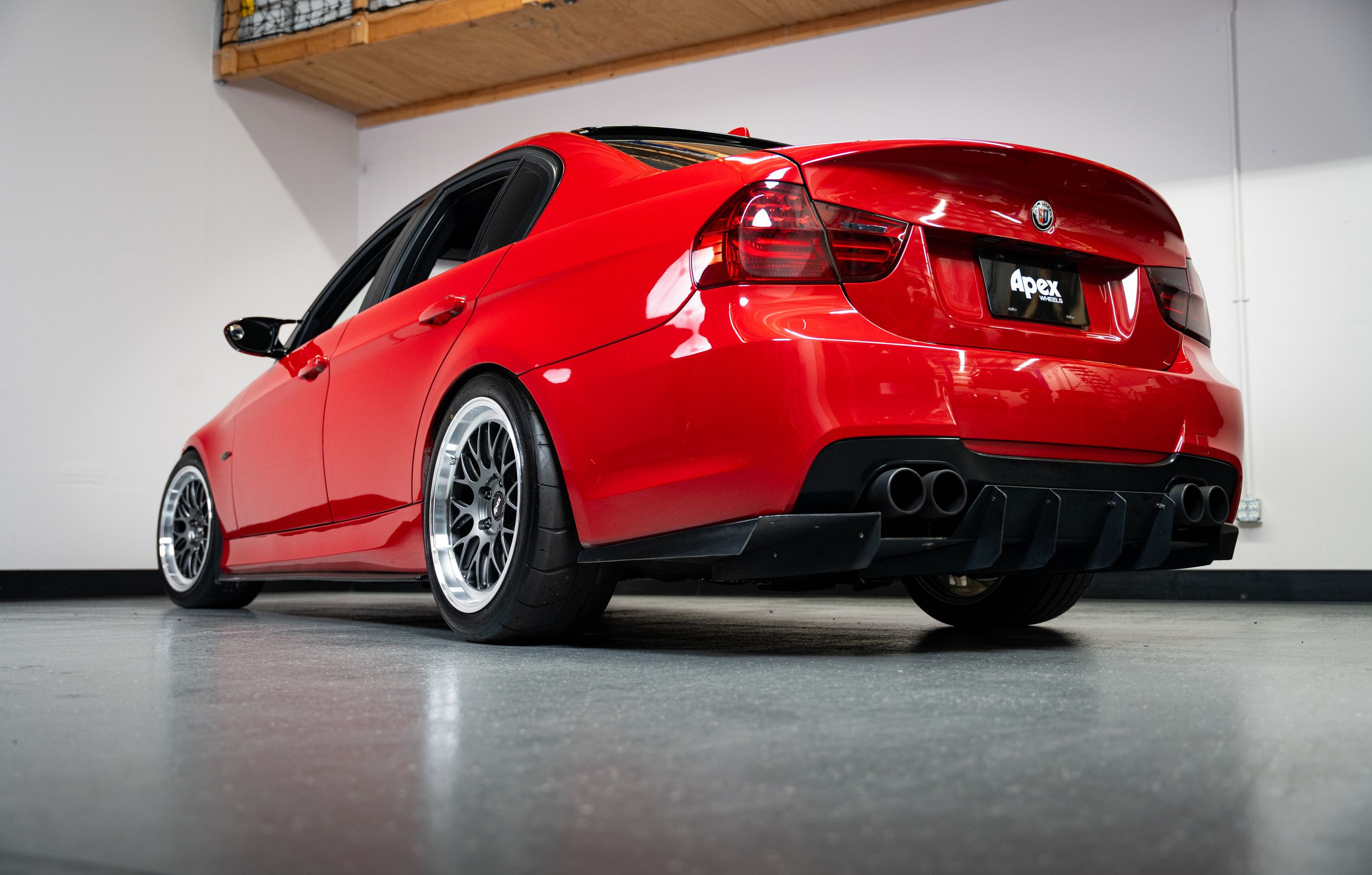 Red BMW E90 Sedan 3 Series with 18" ML-10RT Apex wheels in Machined Lip Anthracite