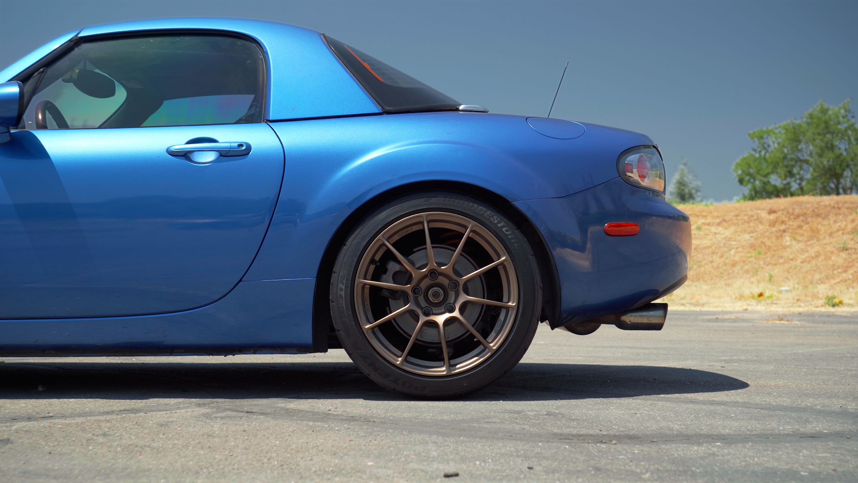 Blue Mazda NC MX-5 Miata with 17" SM-10RS Apex wheels in Satin Bronze