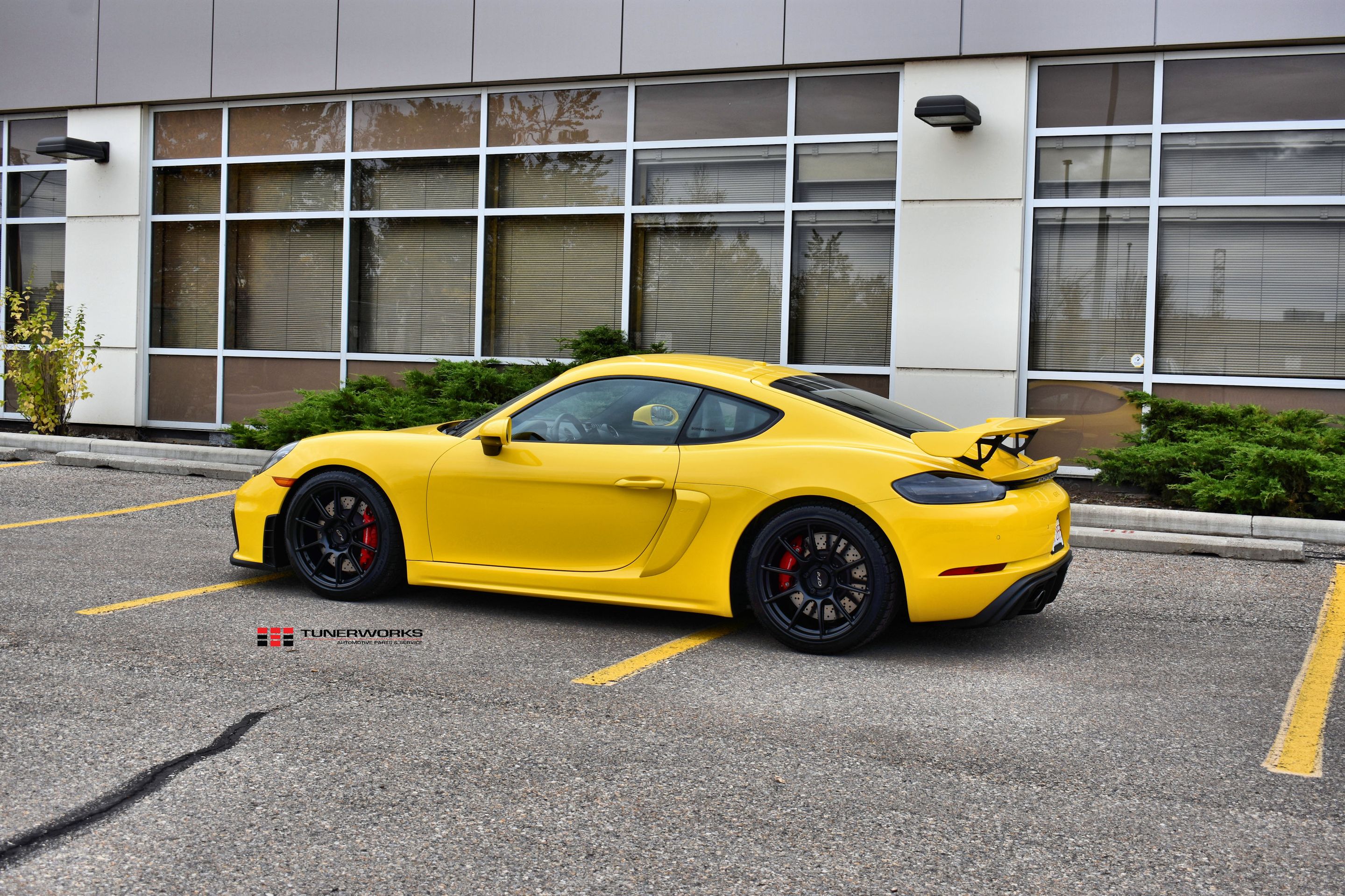 Yellow Porsche 718 Cayman GT4 with 19" SM-10 Apex wheels in Satin Black