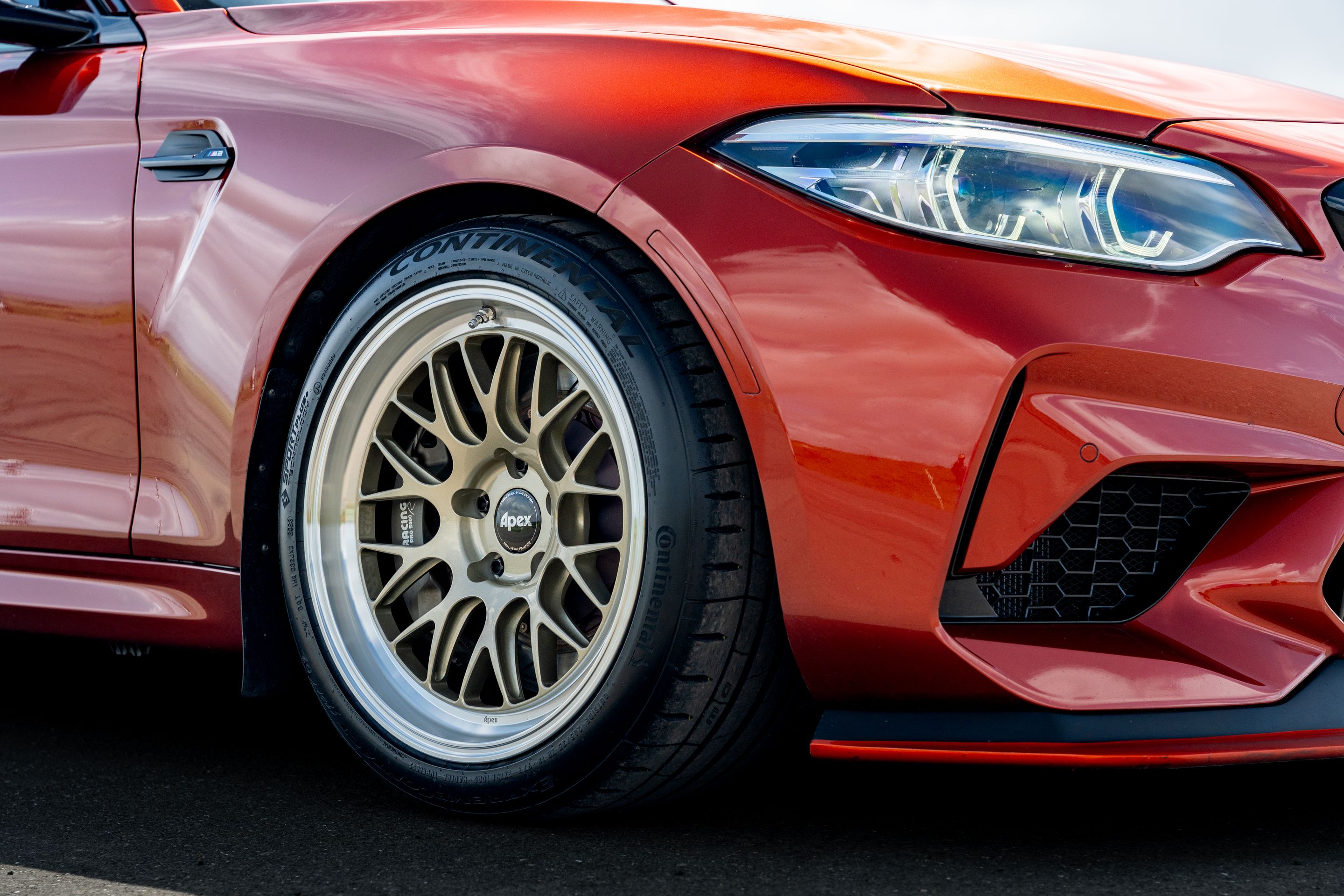 Orange BMW F87 M2 with 18" ML-10RT Apex wheels in Machined Lip Gloss Motorsport Gold