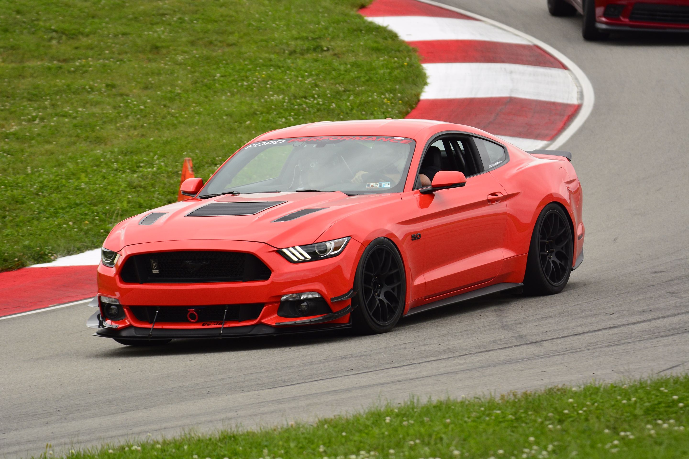 Orange Ford S550 Mustang GT with 19" EC-7 Apex wheels in Satin Black