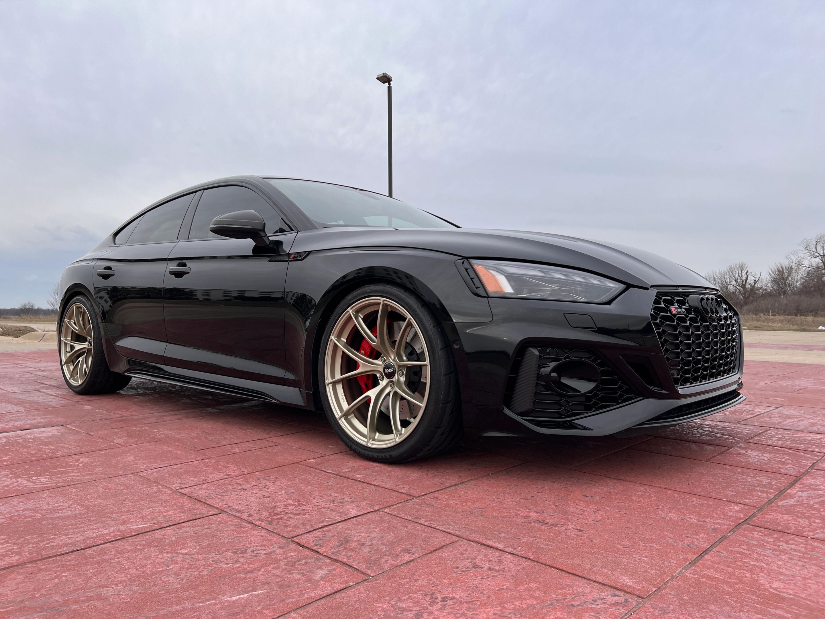 Black Audi B9 RS 5 Sportback with 20" VS-5RS Apex wheels in Motorsport Gold
