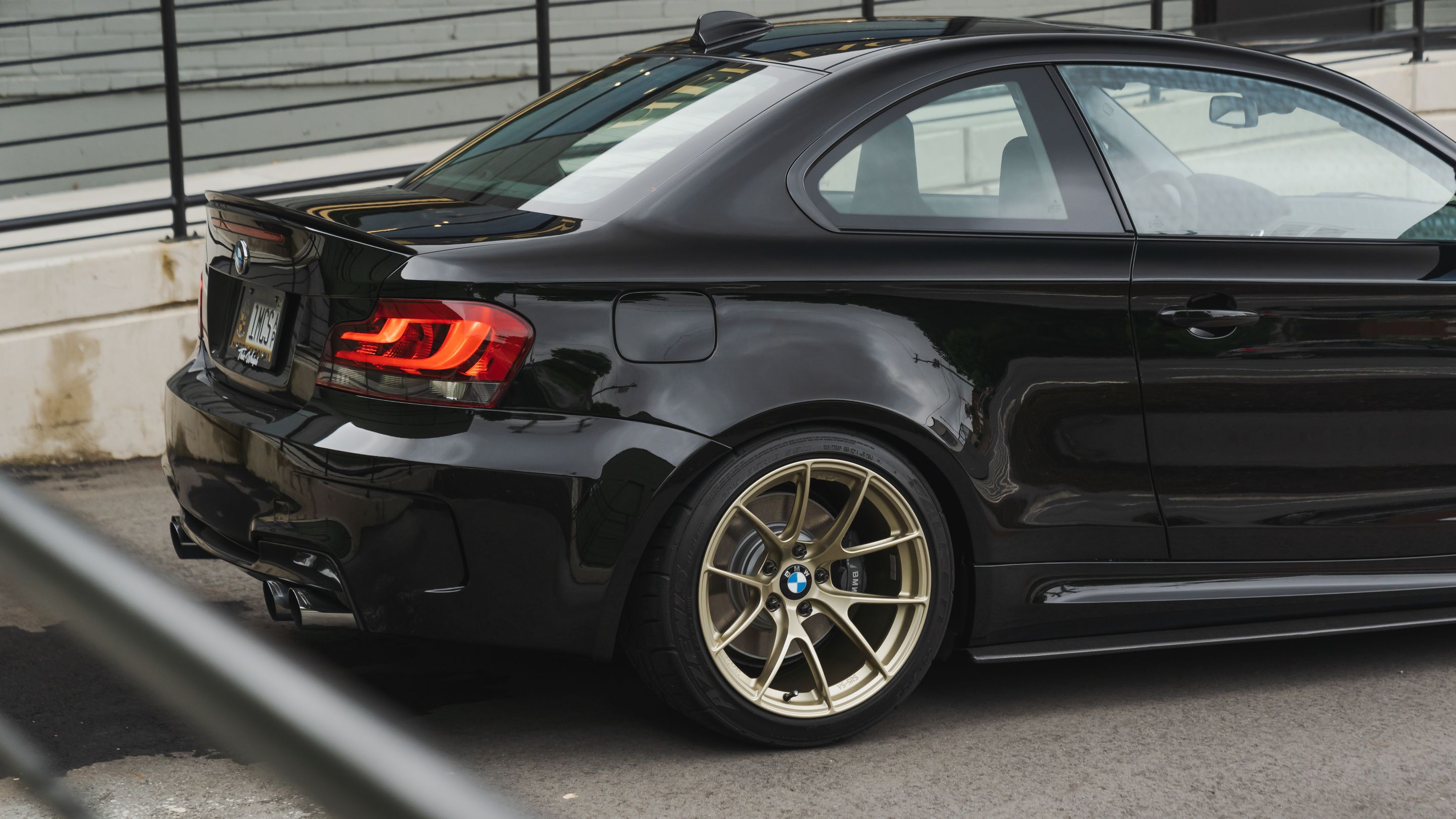 Black BMW E82 Coupe 1 Series with 18" VS-5RS Apex wheels in Motorsport Gold