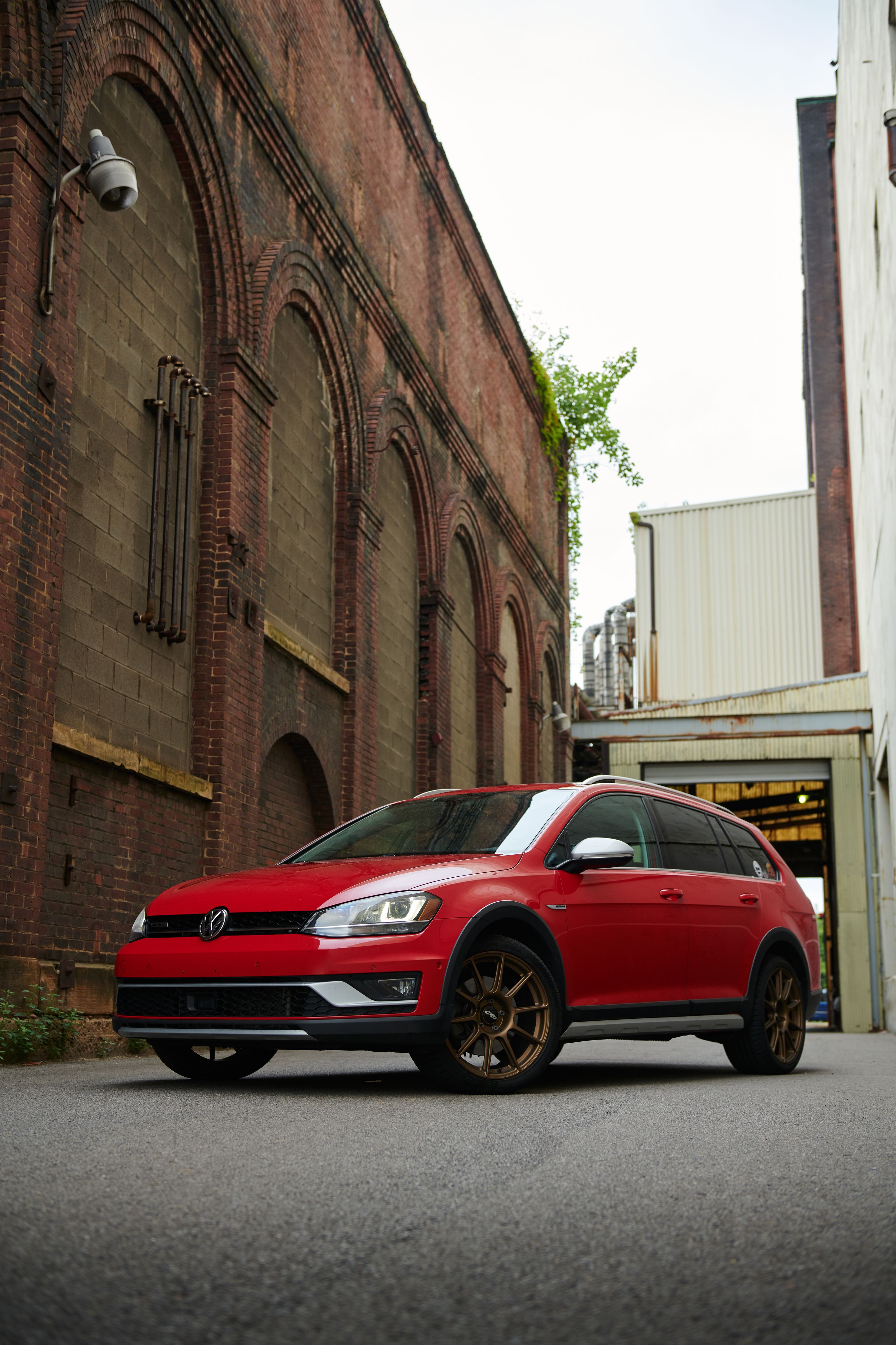 Red VW MK7 Alltrack/SportWagen Alltrack with 18" SM-10 Apex wheels in Satin Bronze