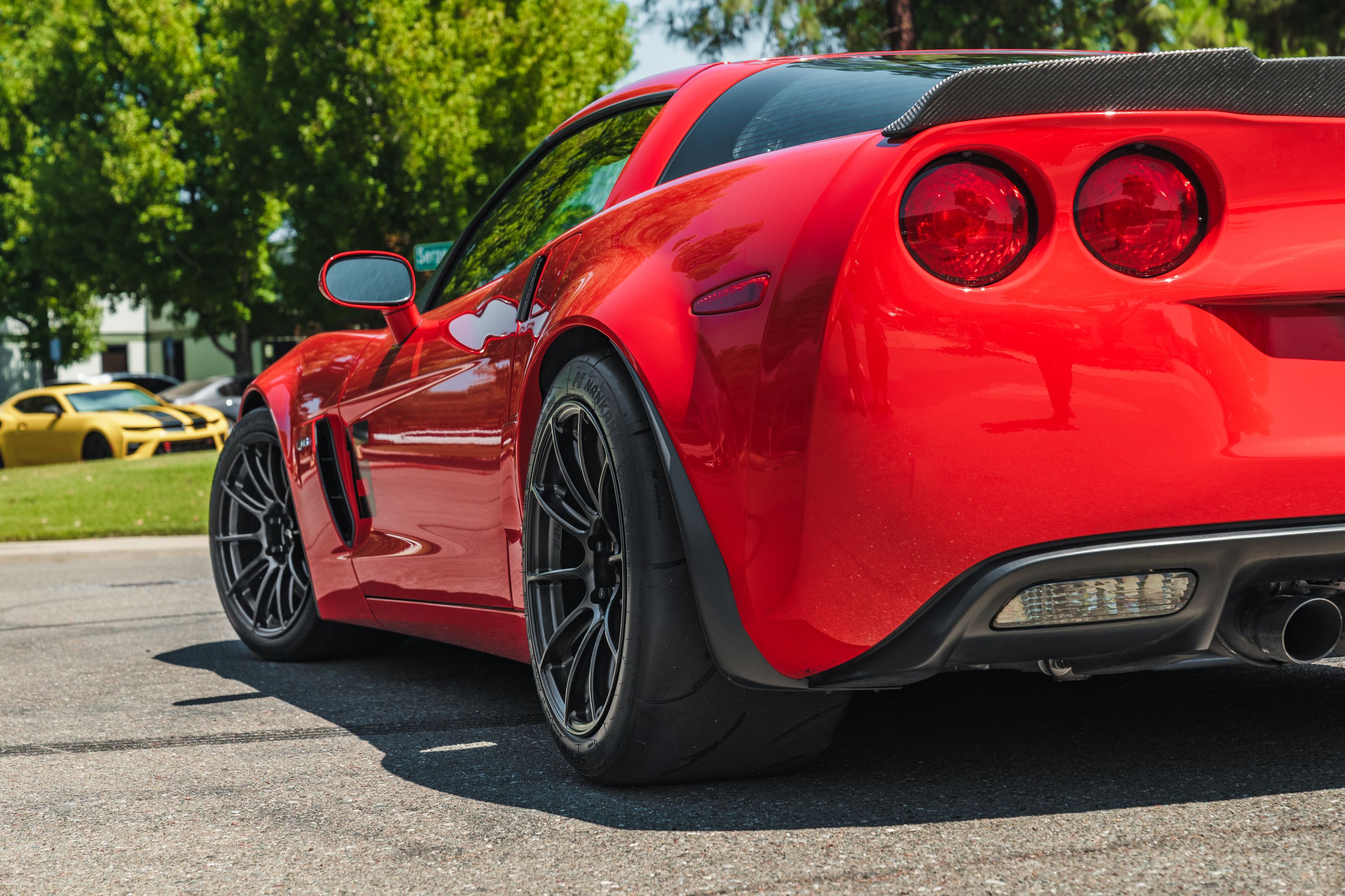 Red Chevrolet C6 Corvette Z06 with 18" SM-10RS Apex wheels in Satin Black