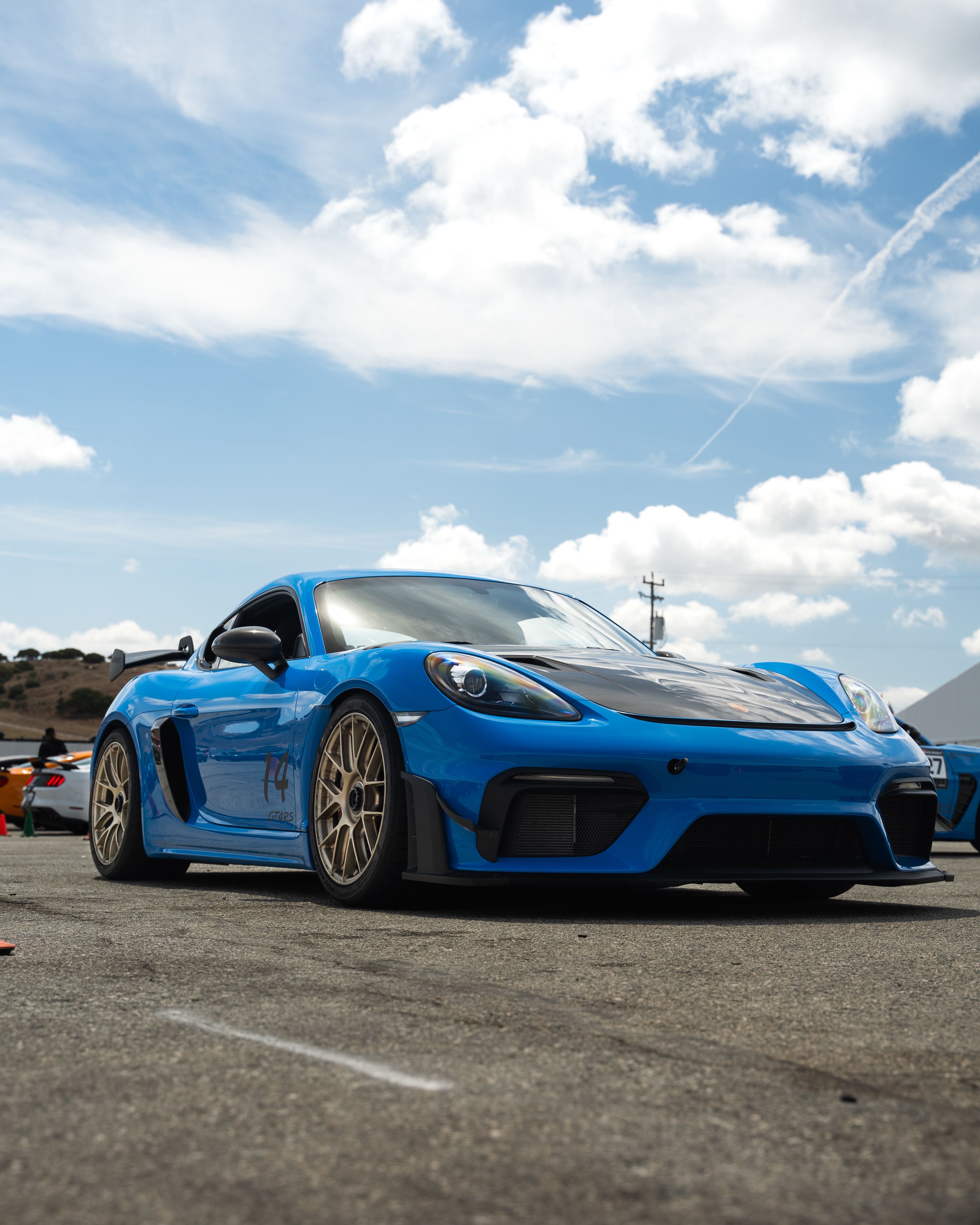 Blue Porsche 718 Cayman GT4 RS with 19" EC-7RS Apex wheels in Motorsport Gold