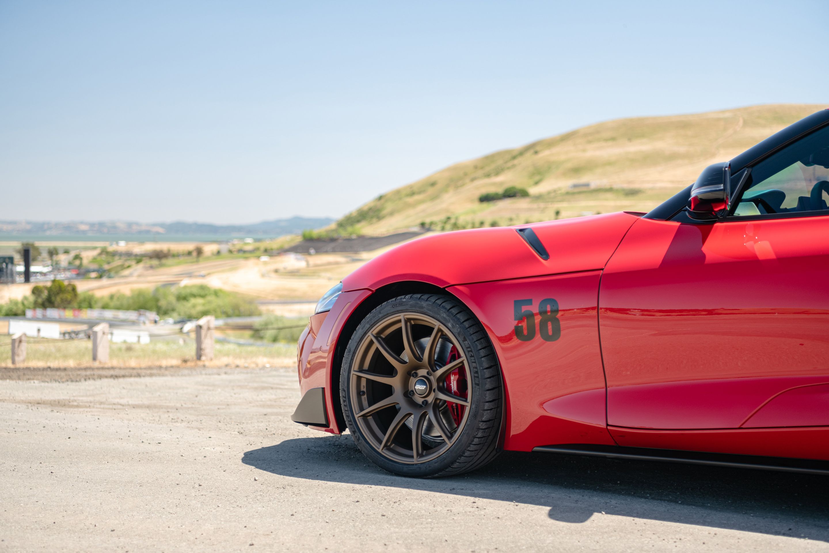 Red Toyota GR Supra with 19" SM-10 Apex wheels in Satin Bronze