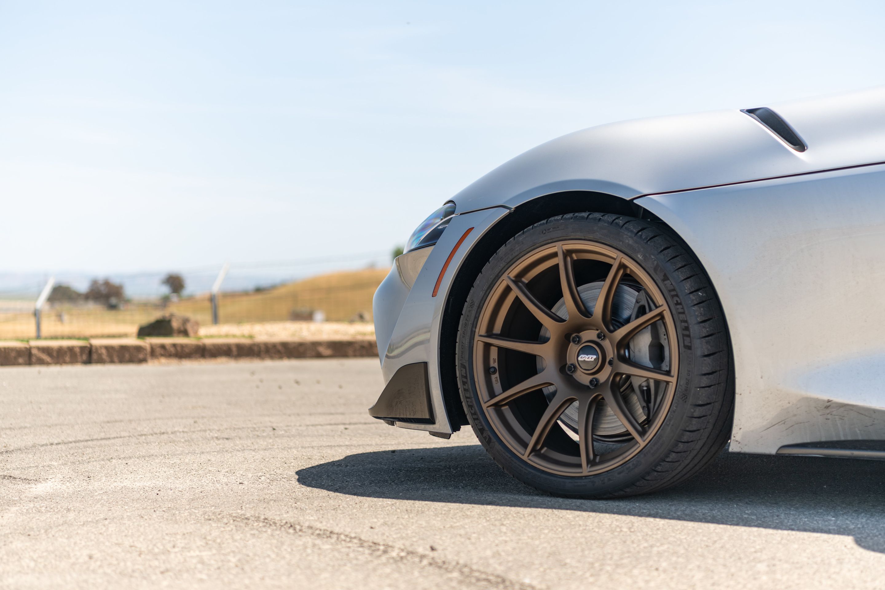 Silver Toyota GR Supra with 19" SM-10 Apex wheels in Satin Bronze