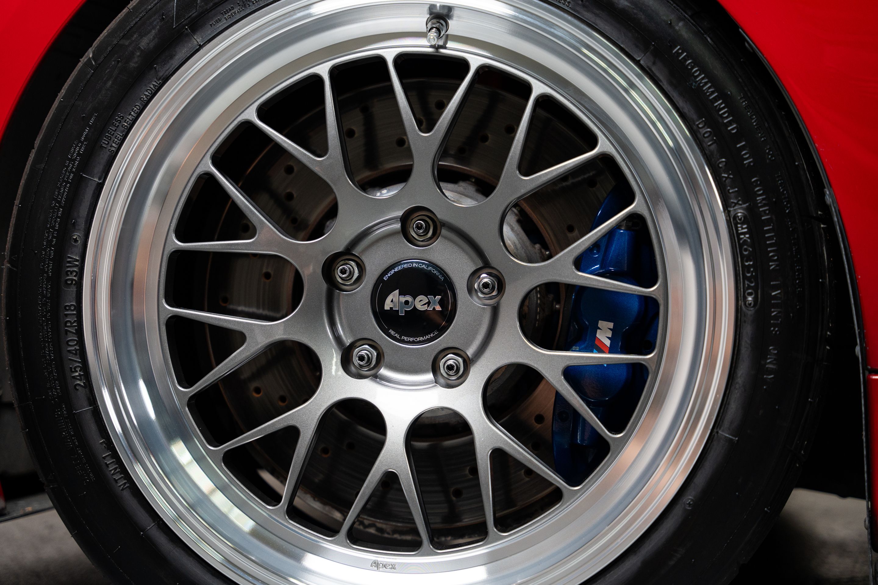 Red BMW E90 Sedan 3 Series with 18" ML-10RT Apex wheels in Machined Lip Anthracite