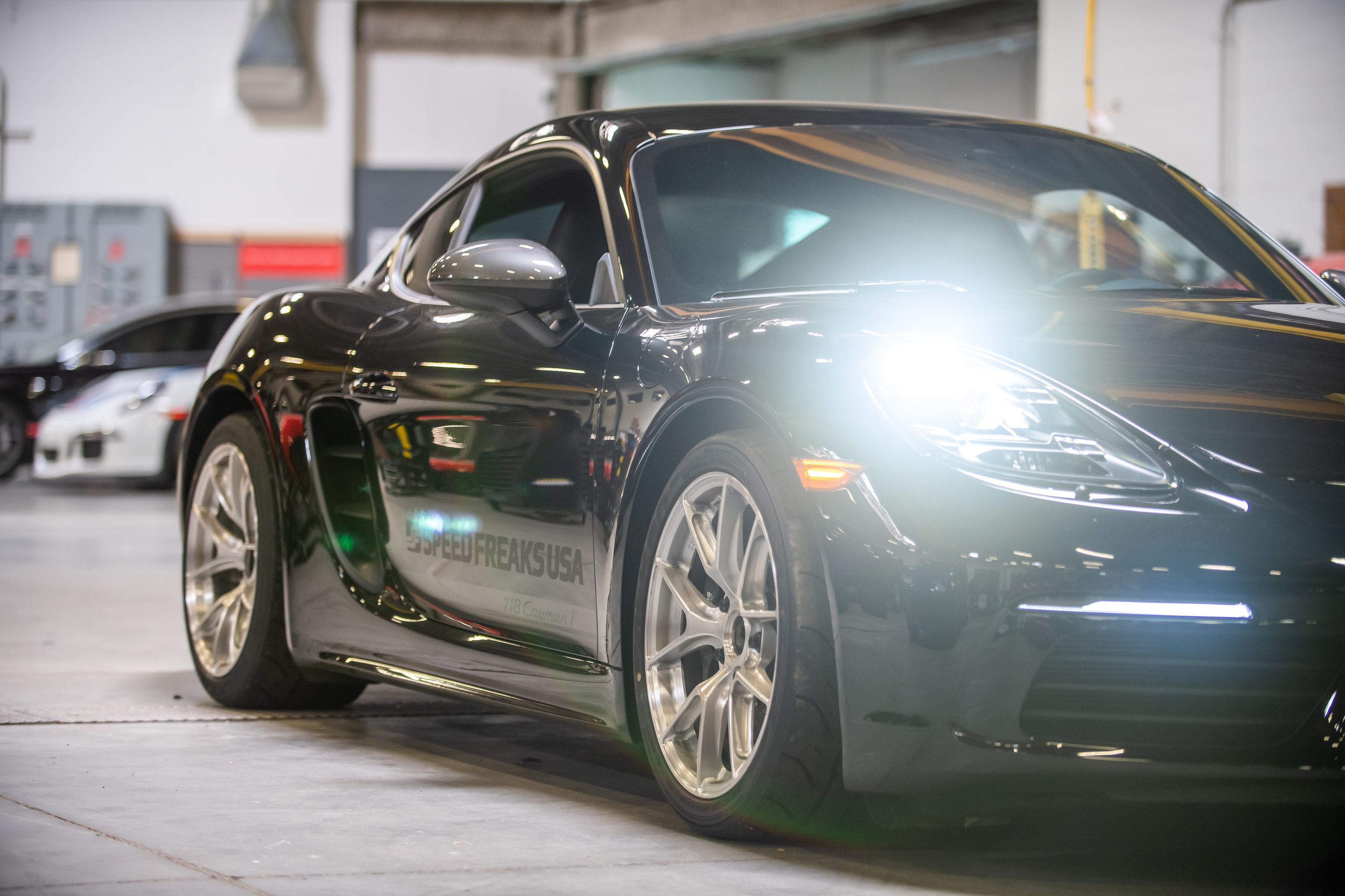 Black Porsche 718 Cayman T with 18" VS-5RS Apex wheels in Brushed Clear