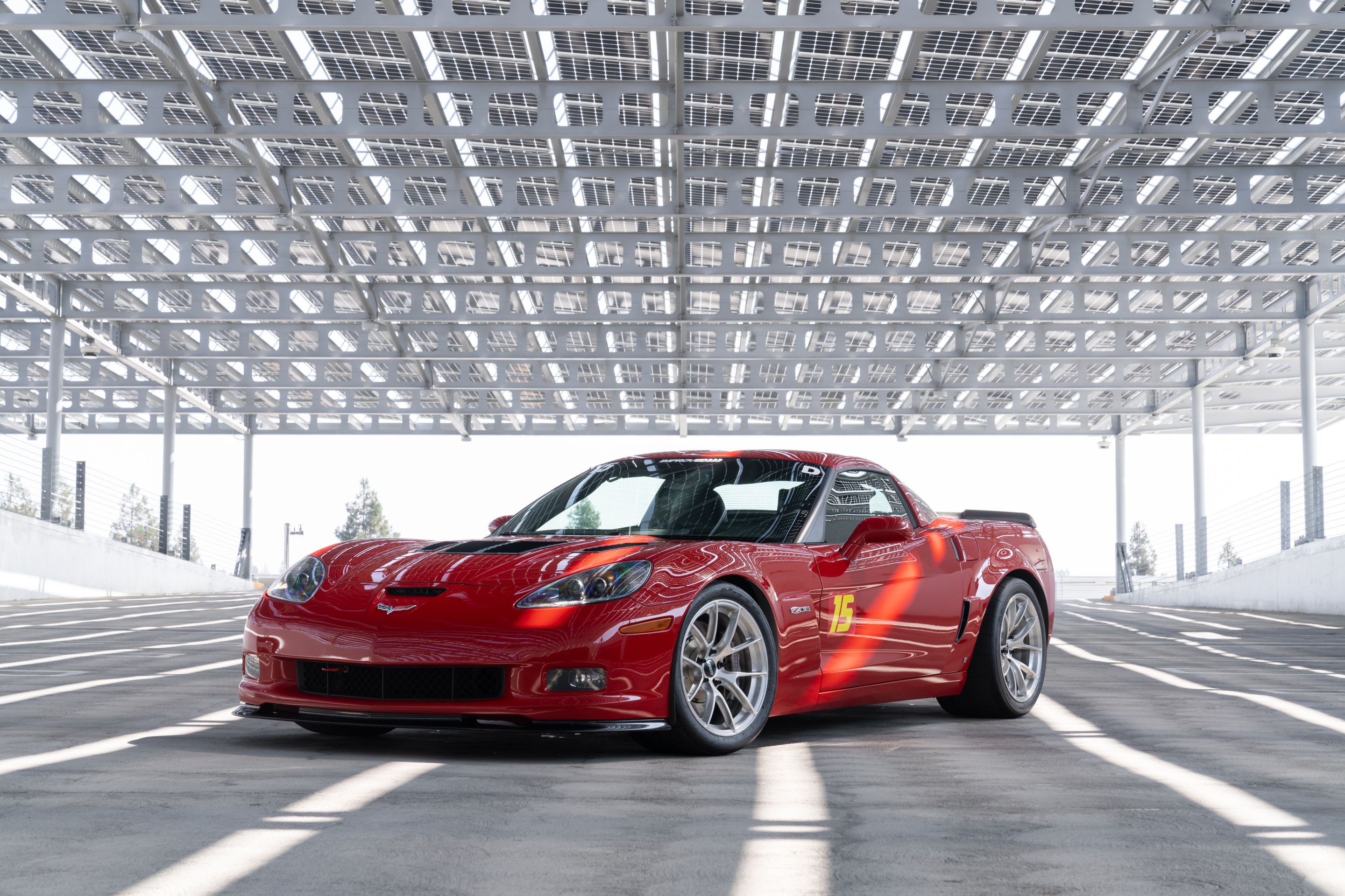 Red Chevrolet C6 Corvette Z06 with 18" VS-5RS Apex wheels in Brushed Clear